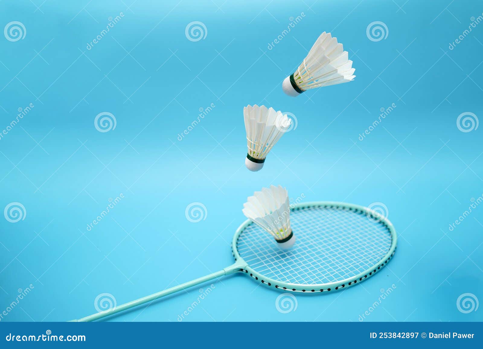 Badminton Shuttlecocks and Badminton Racket on Blue Background Stock