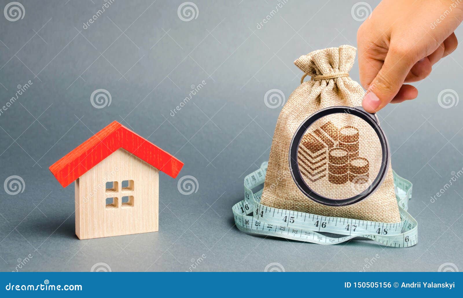 bag with money and tape measure with a wooden house. the concept of a limited real estate budget. low subsidies. lack of