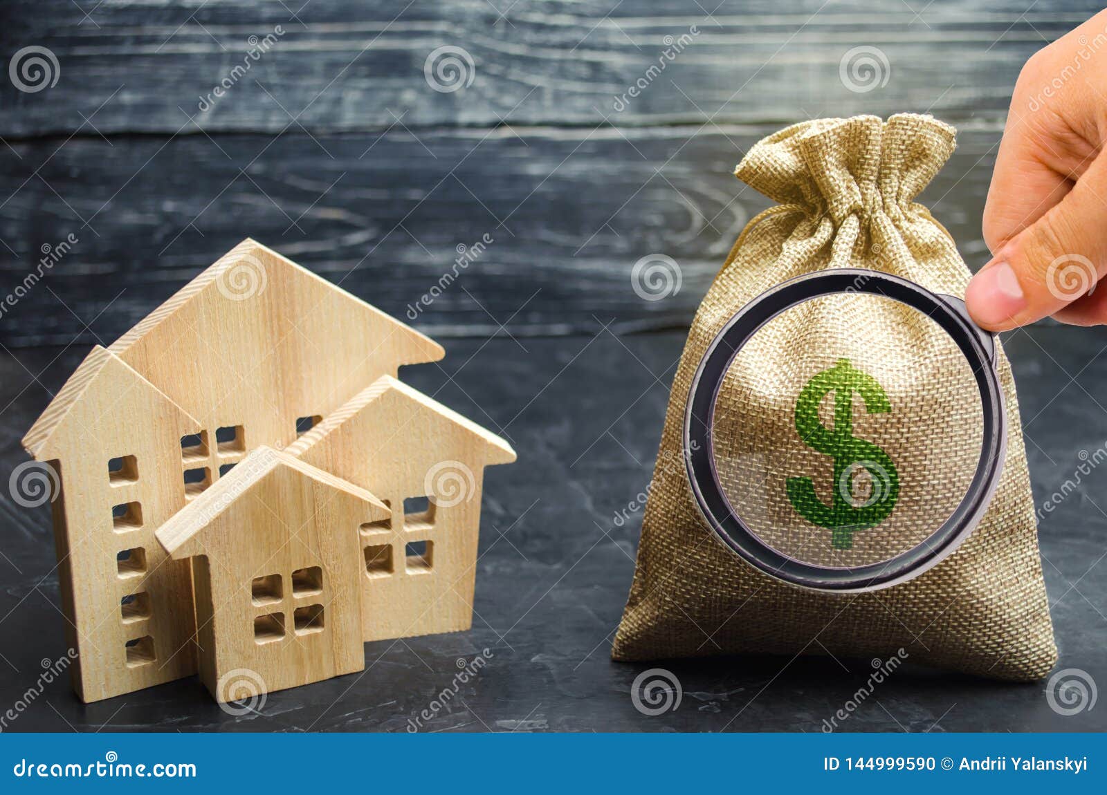 a bag with money and wooden houses. selling a house. apartment purchase. real estate market. rental housing for rent. home prices