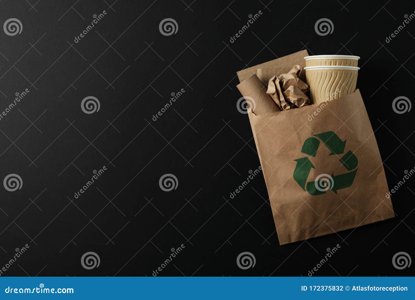 Bag With Paper Trash And Recycle Sign On Black Background Stock Photo