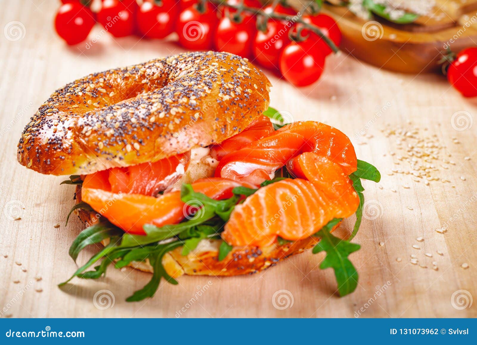 Bagel With Cream Cheese Smoked Salmon And Arugula Salad On Wooden Board Stock Photo Image Of Cream Breakfast 131073962