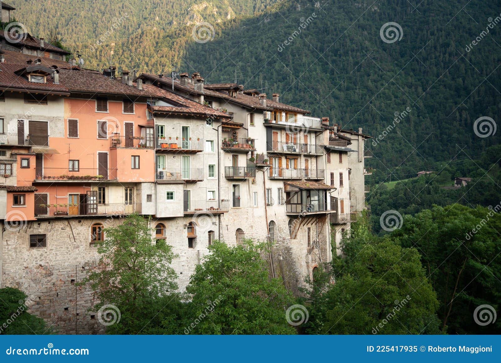 bagolino medieval village. old buildings and forested slopes.