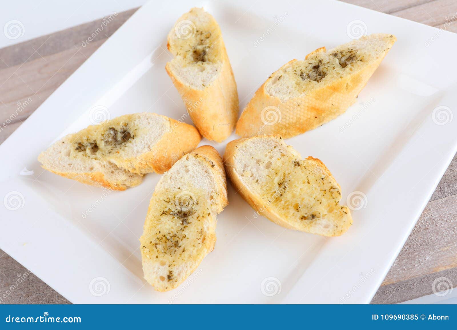 Baguette with herb butter stock image. Image of plate 109690385