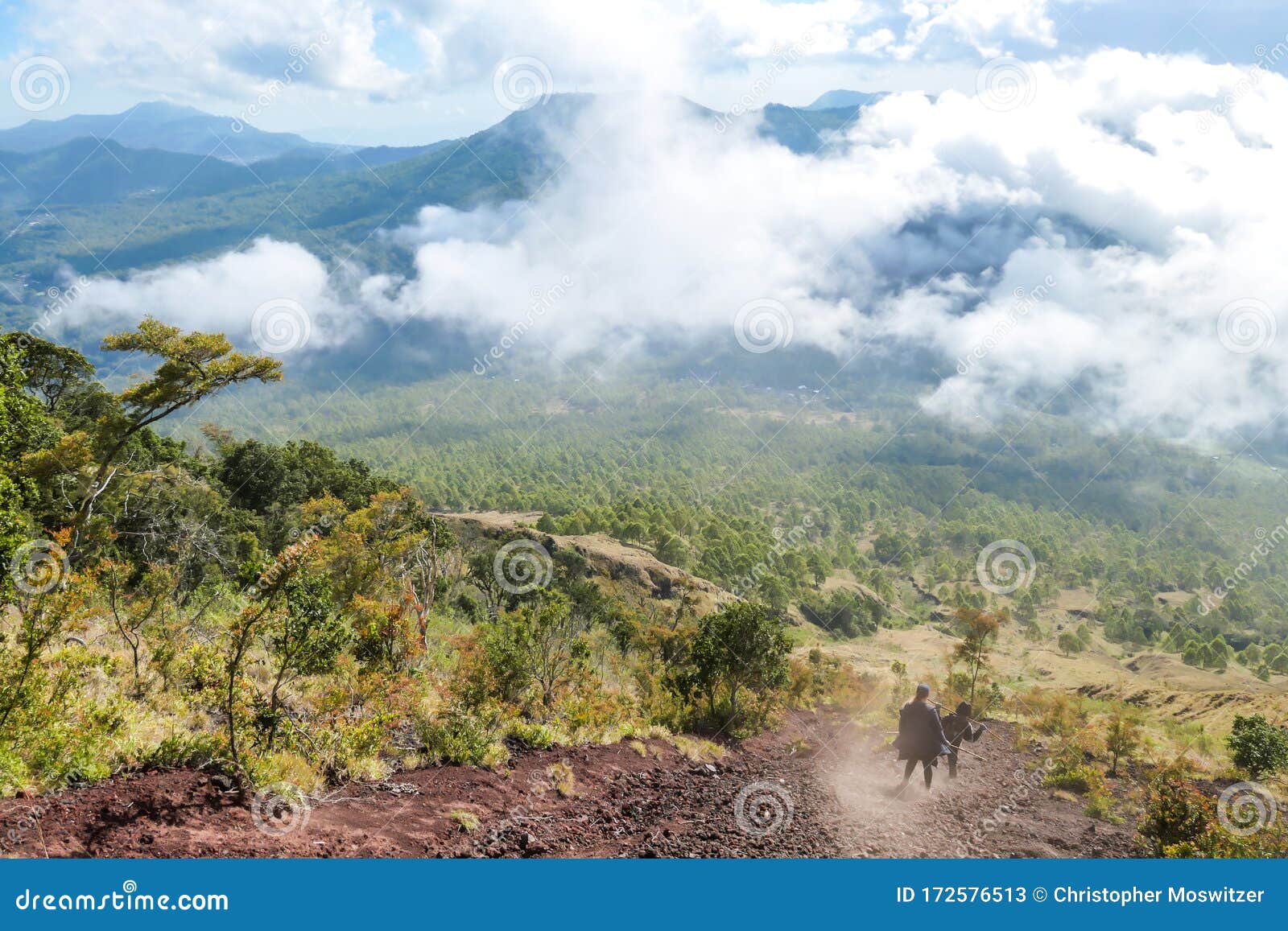 bajawa - a couple going down a steep slopes of volcano inierie