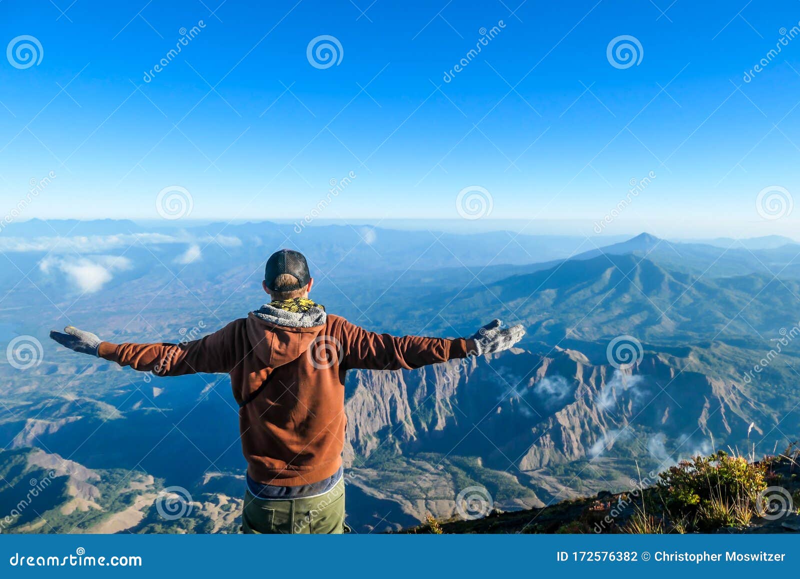 bajawa - a man standing on the top of the volcano, admiring the view