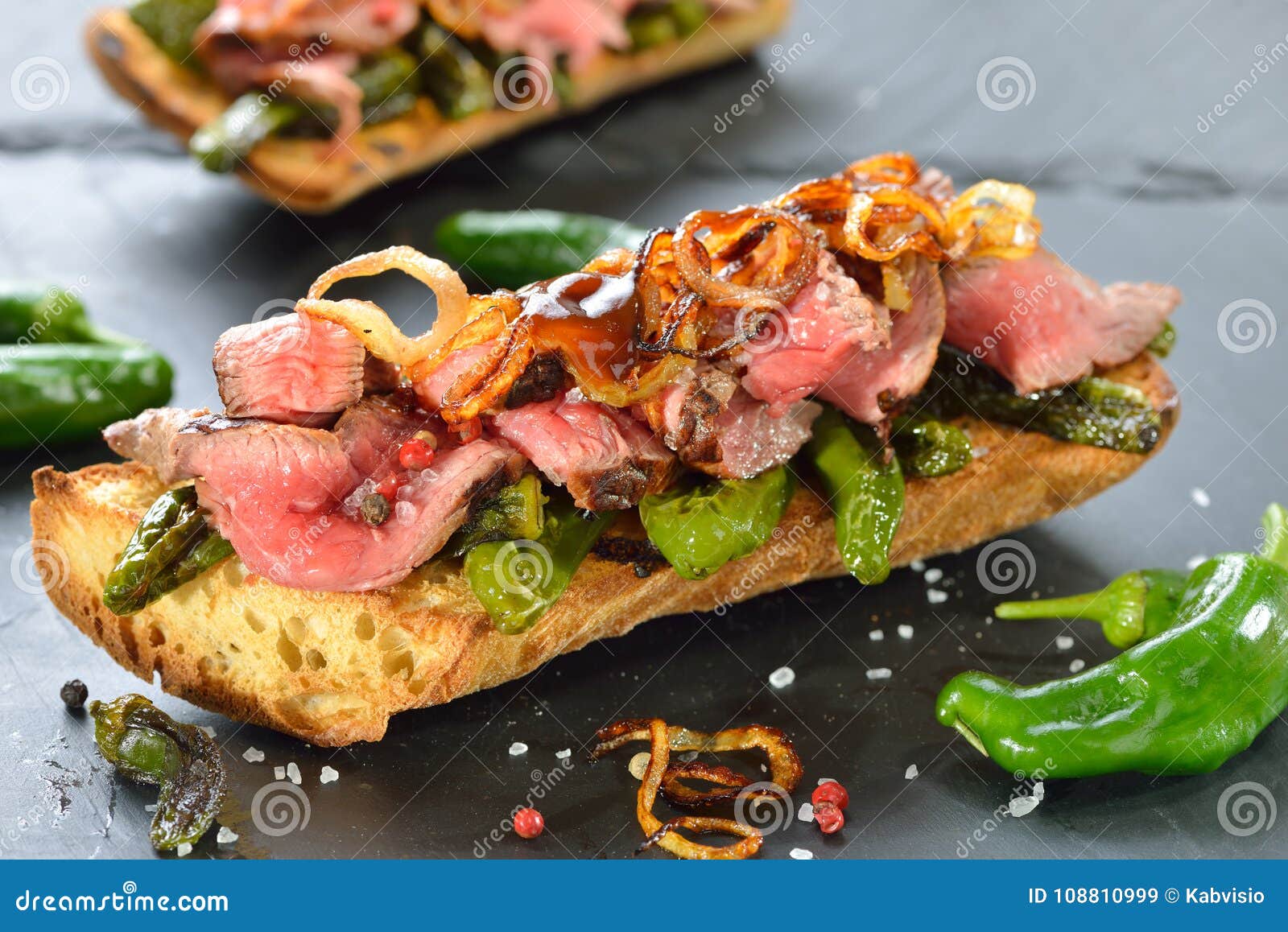 baked baguette with pimientos and steak