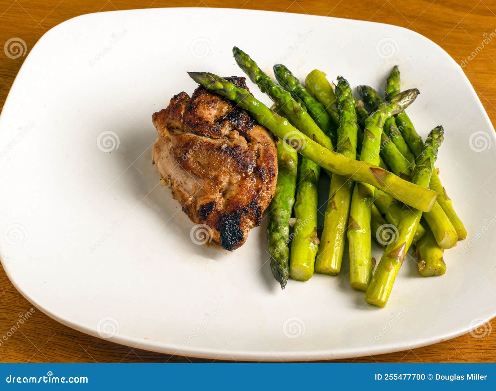 Baked Chicken Thigh Served with Sauteed Asparagus Stock Photo Image
