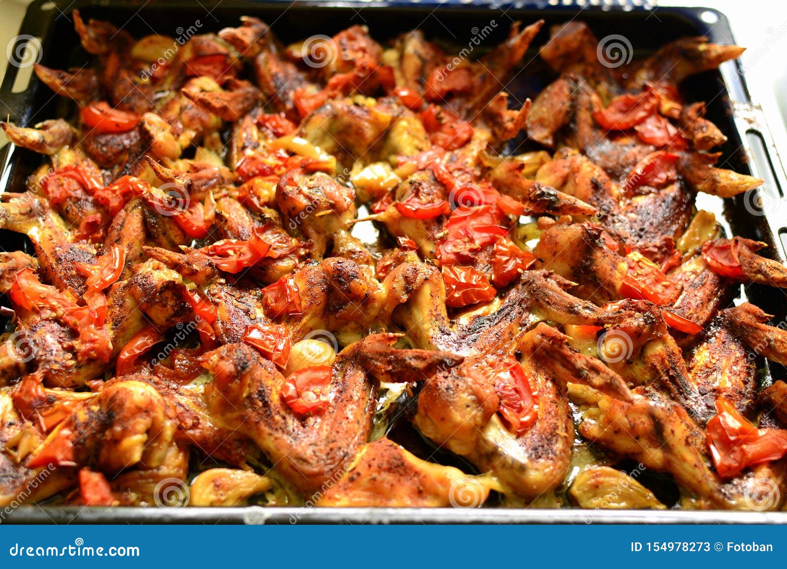 baked chicken wings on pepper a with garlic and tomate