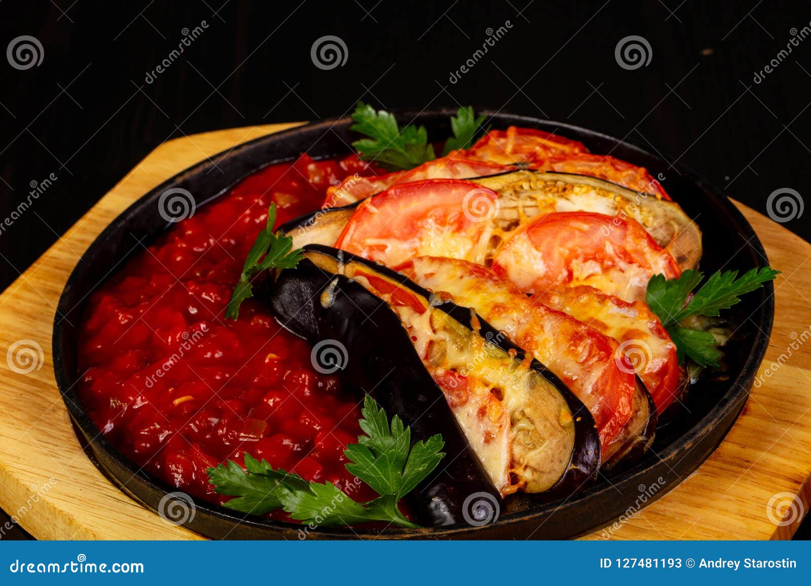 Baked eggplant with tomato stock image. Image of dish 127481193