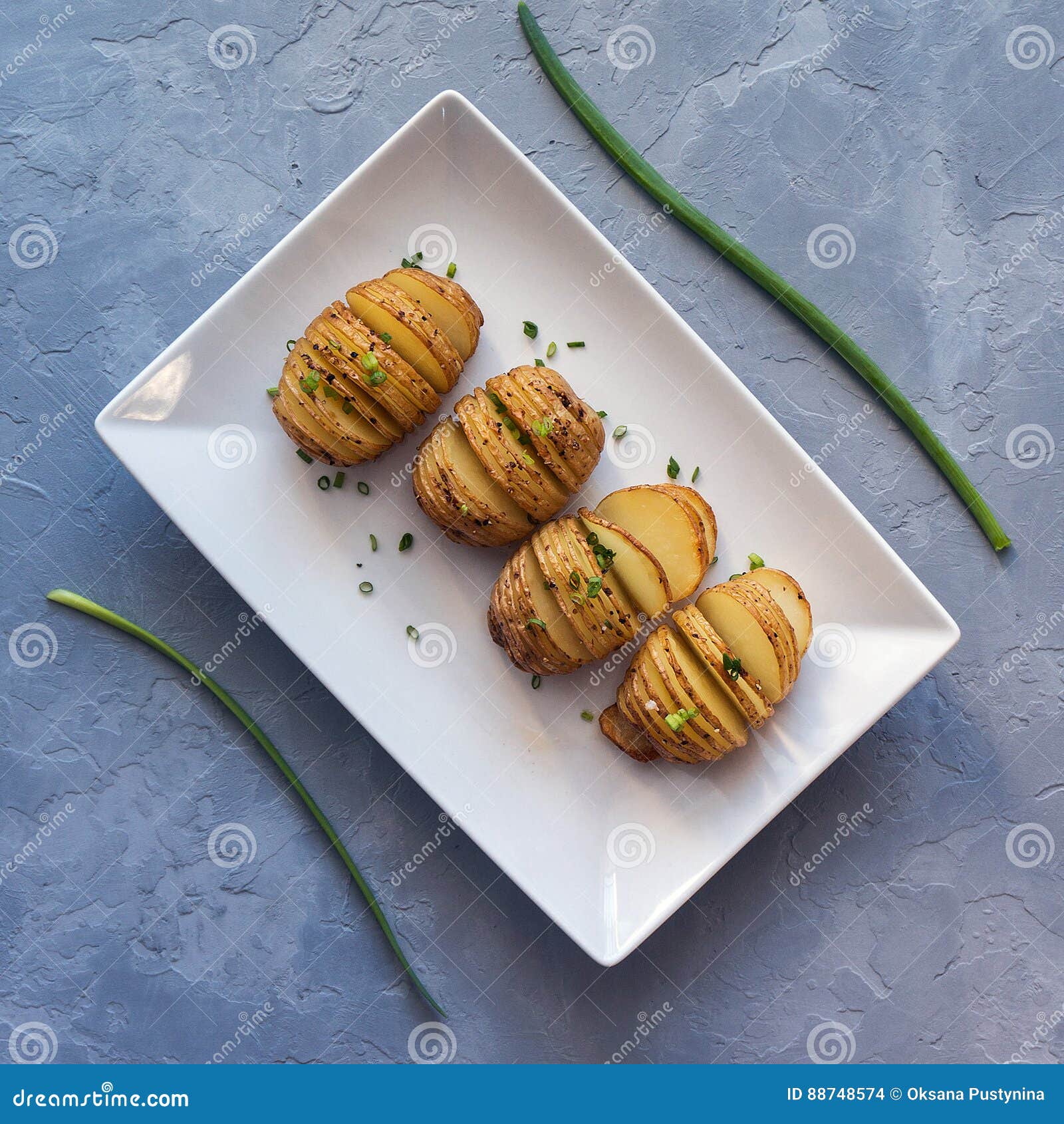 Baked Hasselback Potatoes with Onion and Spice. Top View Stock Photo