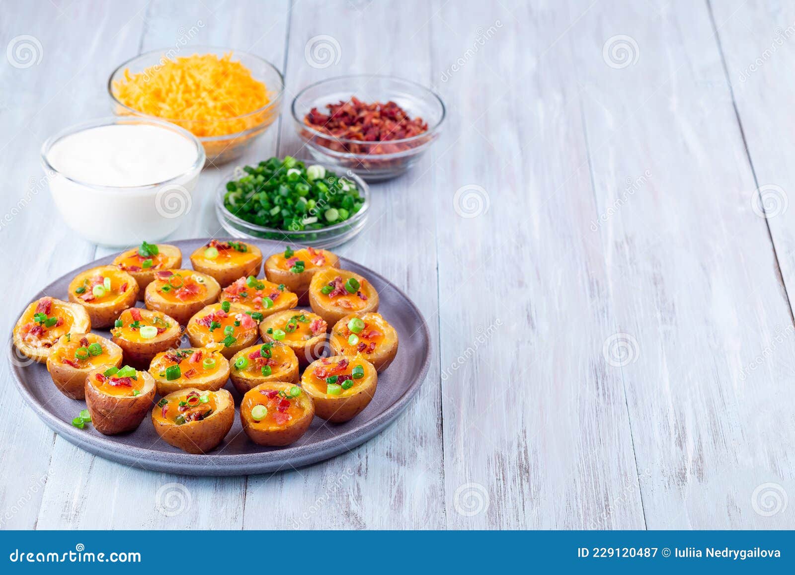 baked mini red skinned loaded potatoes with crispy bacon, scallions and sharp cheddar cheese