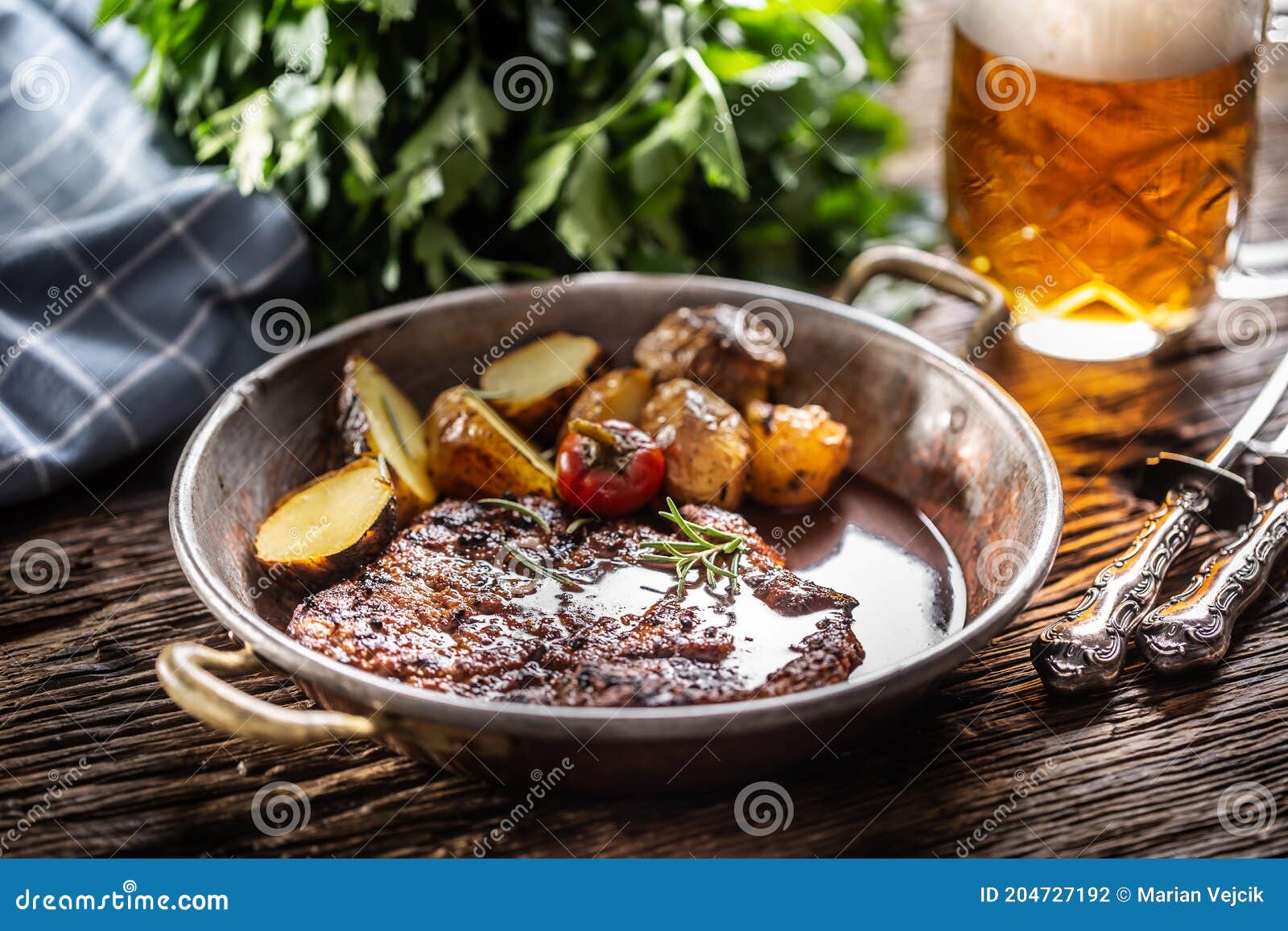 baked pork nech with potaties served in metallic vintage bowl and beer