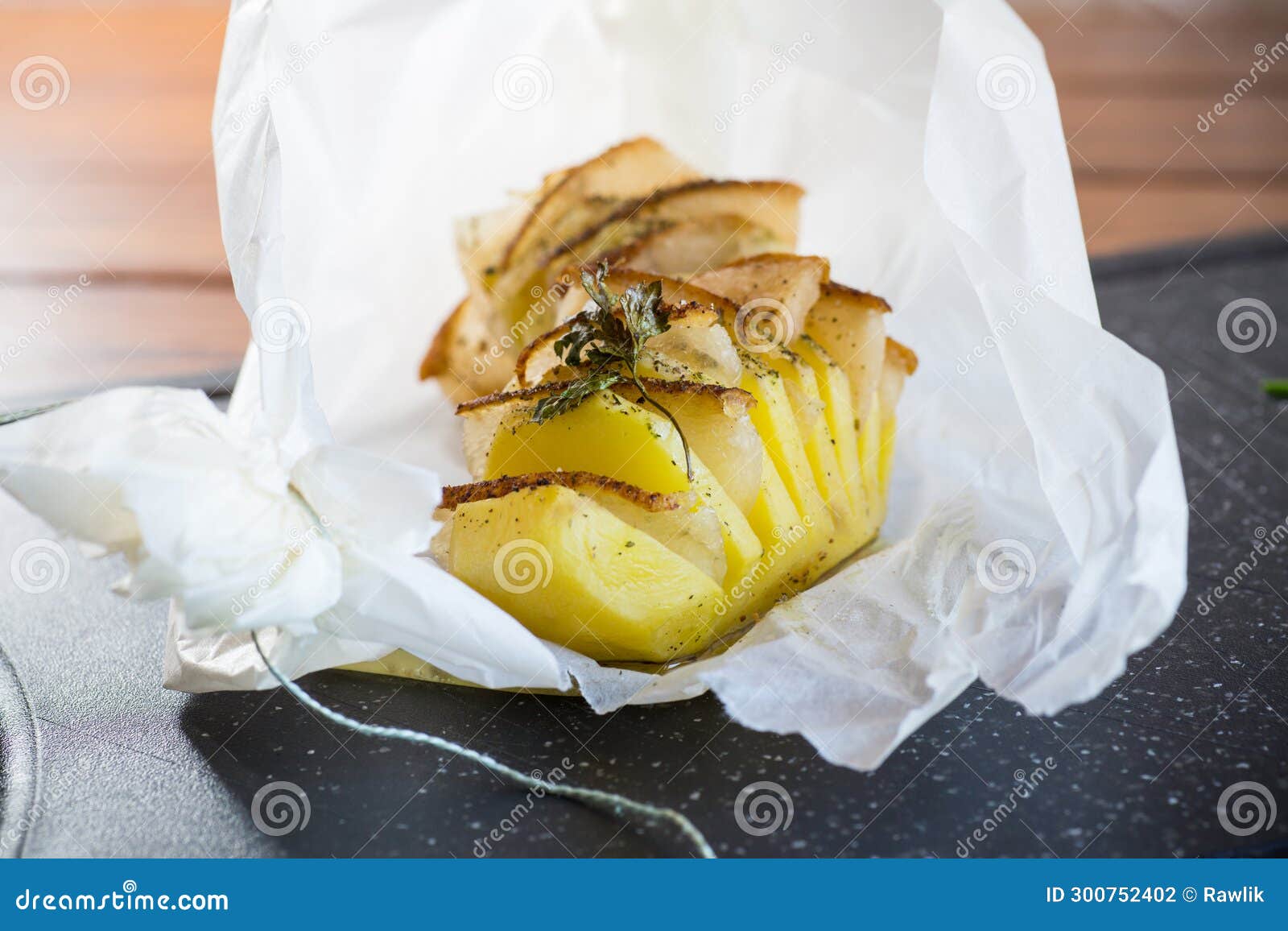 Baked Potatoes Stuffed with Lard in Baking Paper. Stock Photo Image
