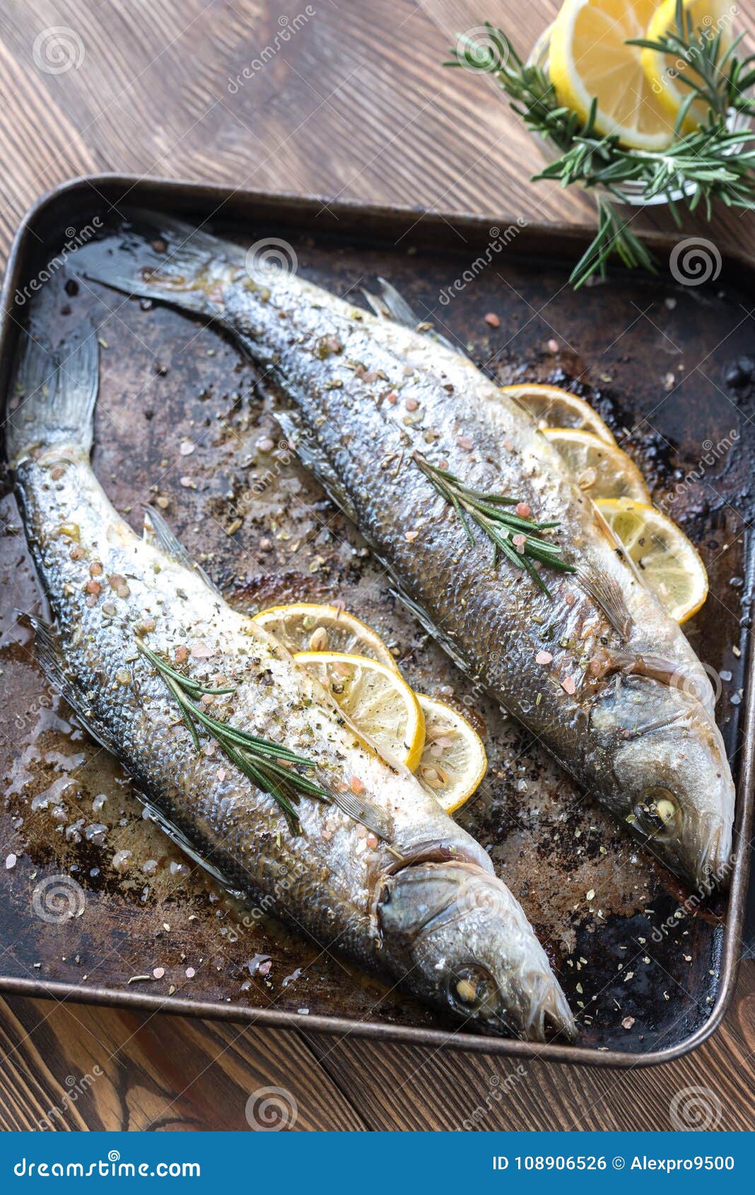 Baked Sea Bass with Lemon and Rosemary Stock Photo - Image of european ...