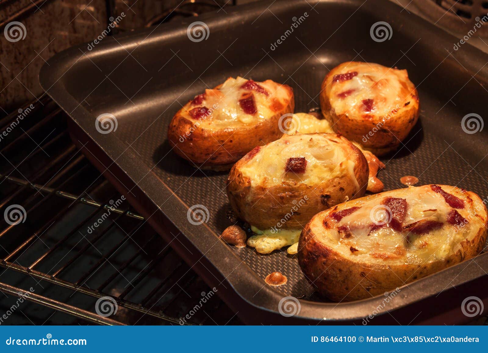 Baked Stuffed Potatoes in the Kitchen Oven. Stock Photo Image of