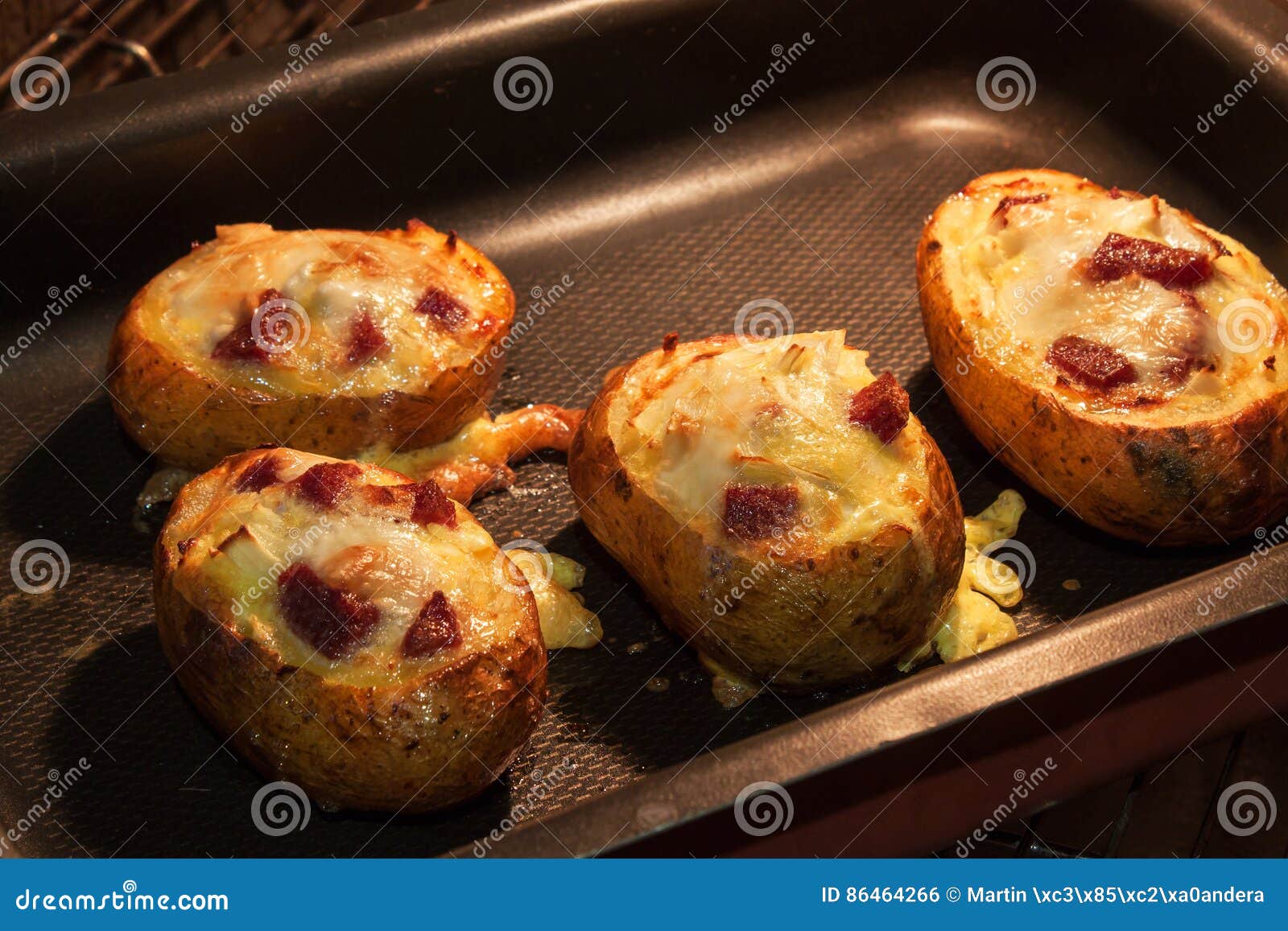 Baked Stuffed Potatoes in the Kitchen Oven. Stock Photo Image of