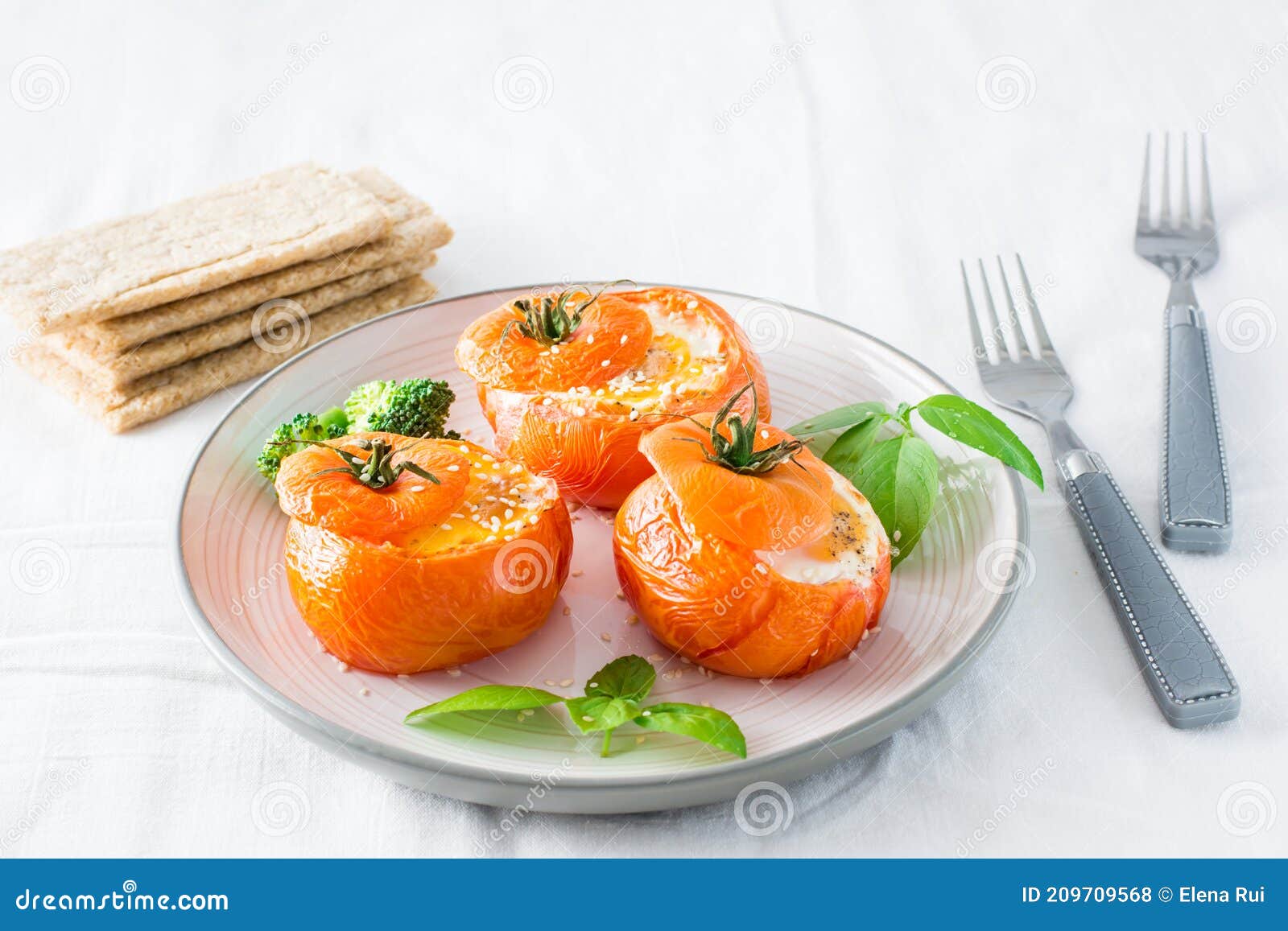 Baked Tomatoes with Egg and Basil Leaves on the Table. Diet Lunch Stock