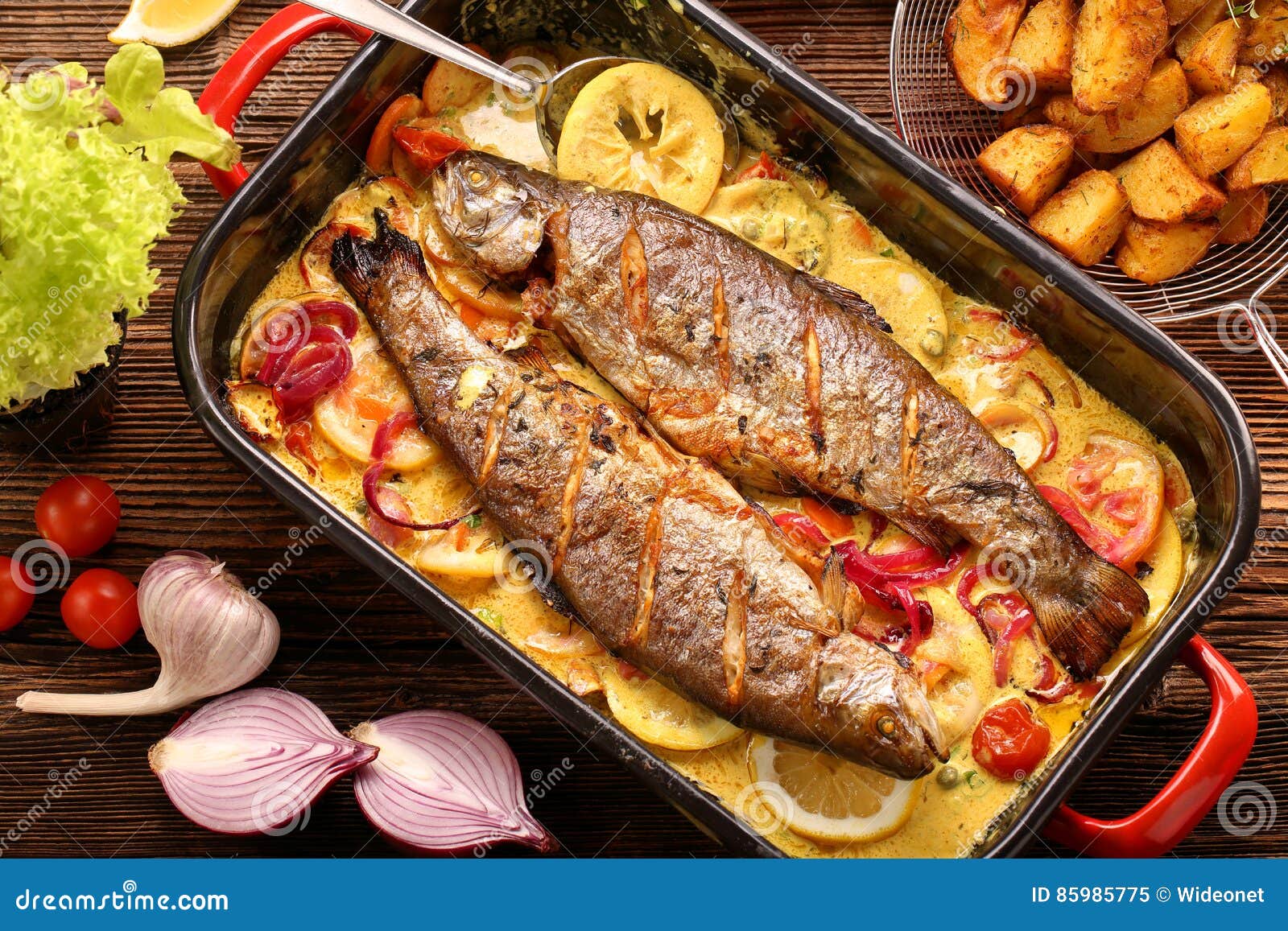 Baked Trout with Lemon Sauce and Vegetables in a Pan Stock Image
