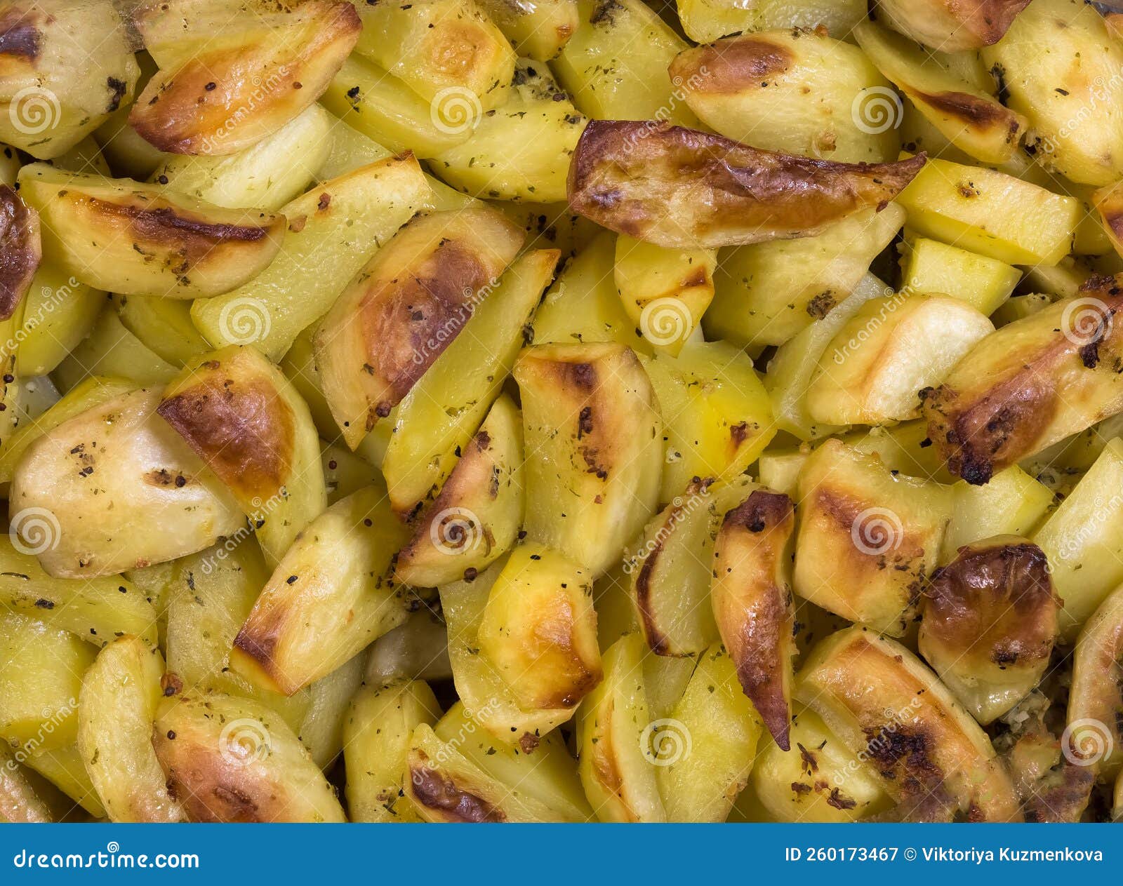 Baked Yellow Potatoes with Burnt Edges. Potatoes with Spices Stock