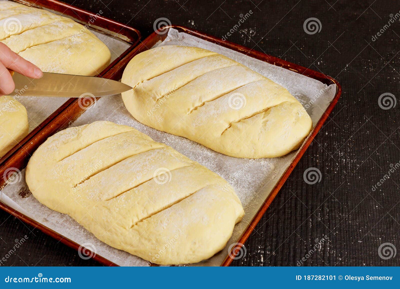 Baker Cuts Uncooked Bread Dough on Rack Ready for Baking Stock Image