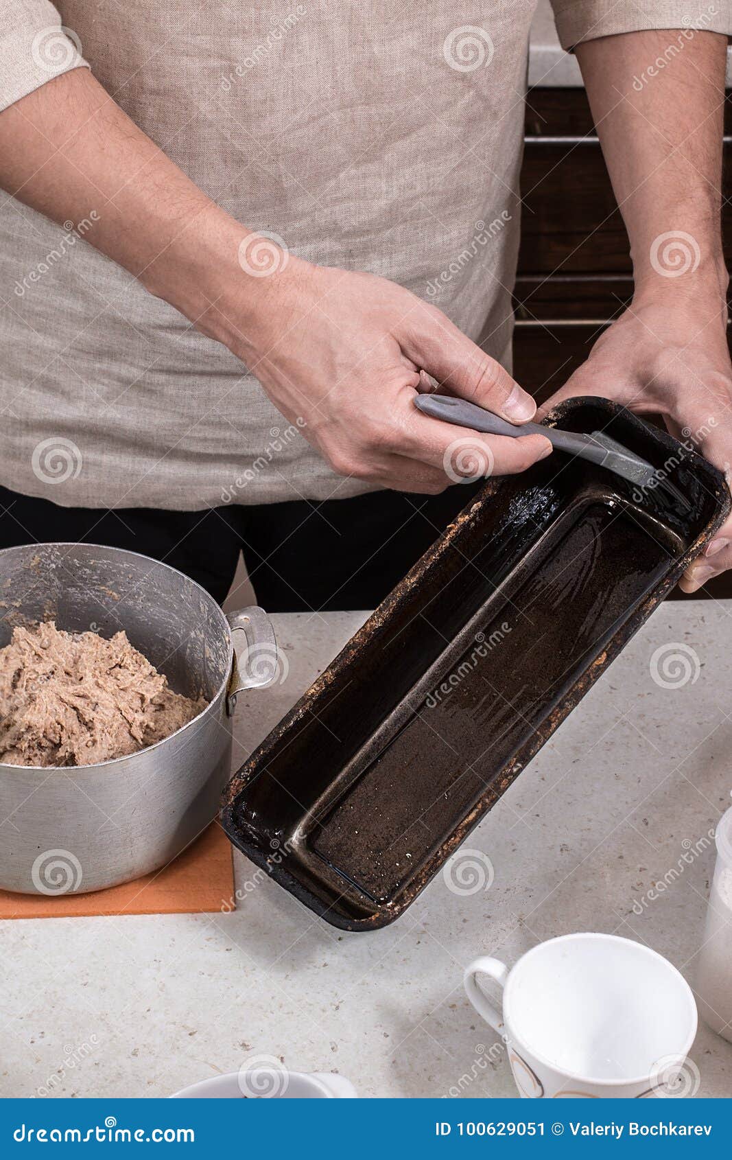Baker Greases a Bread Baking Dish. Stock Image Image of bakery, baker