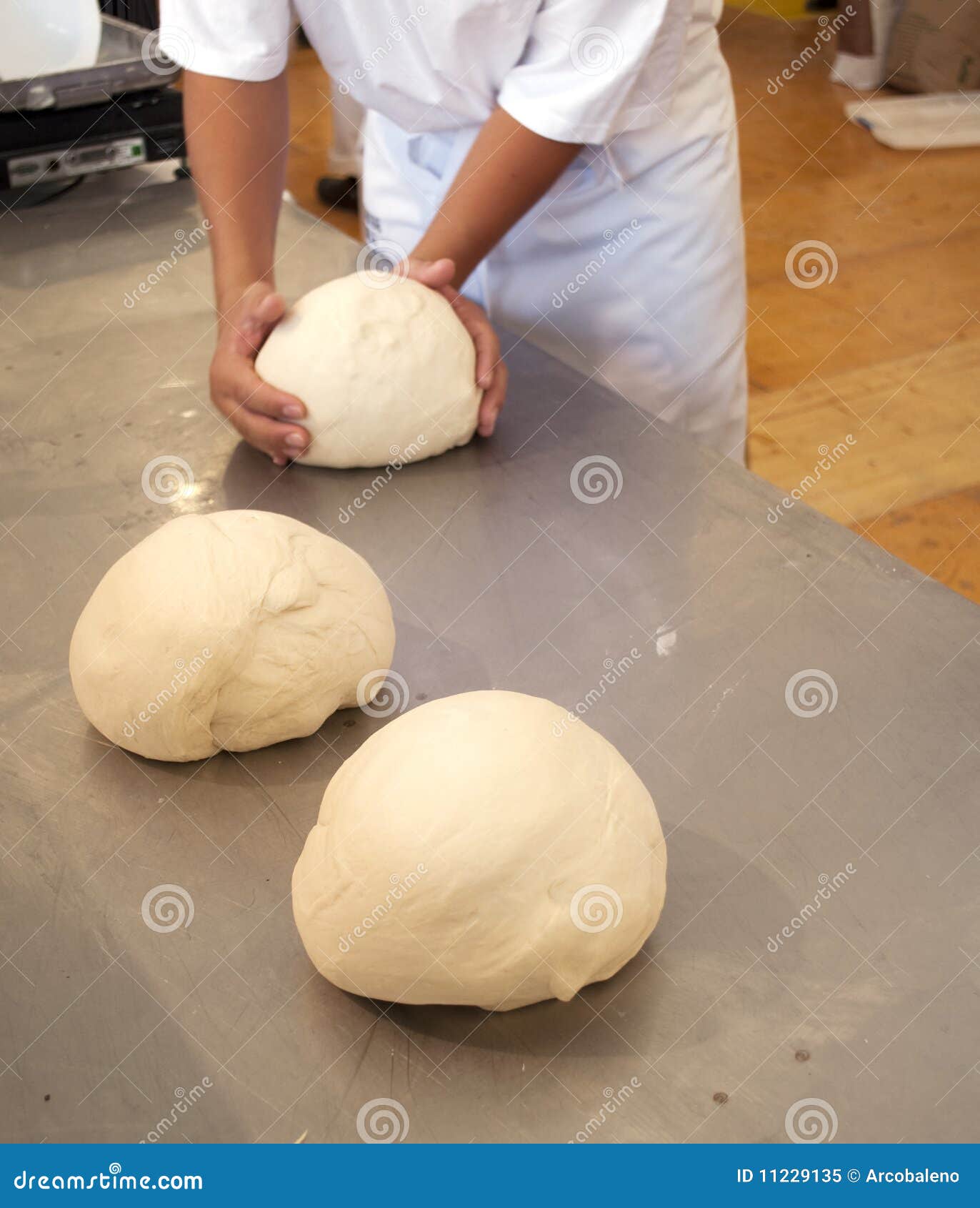Baker Hands Kneading Bread Dough In Bakery. Making Bread. Men Manually