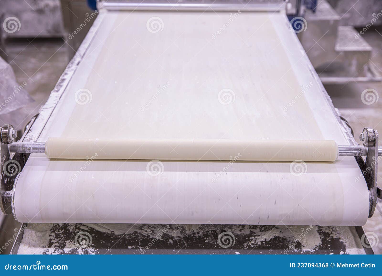 Baker Making Dough for Pastry on Dough Sheeter. Dough Rolling Machine