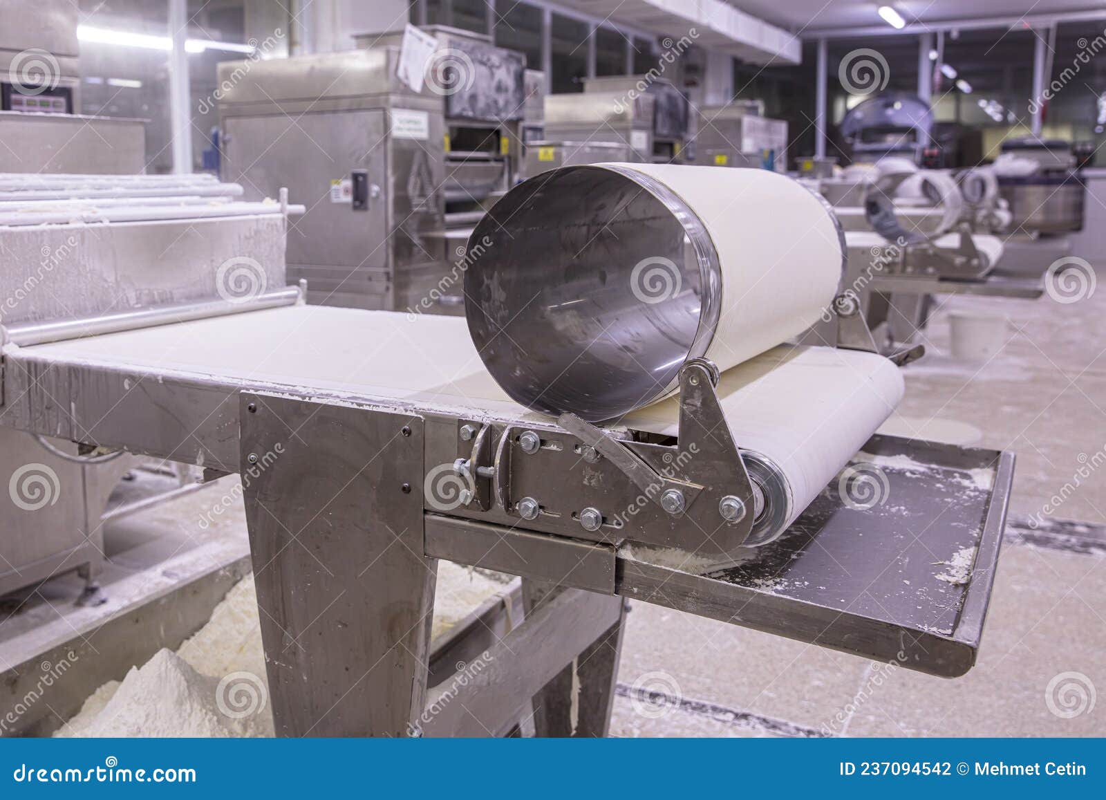 Baker Making Dough for Pastry on Dough Sheeter. Dough Rolling Machine