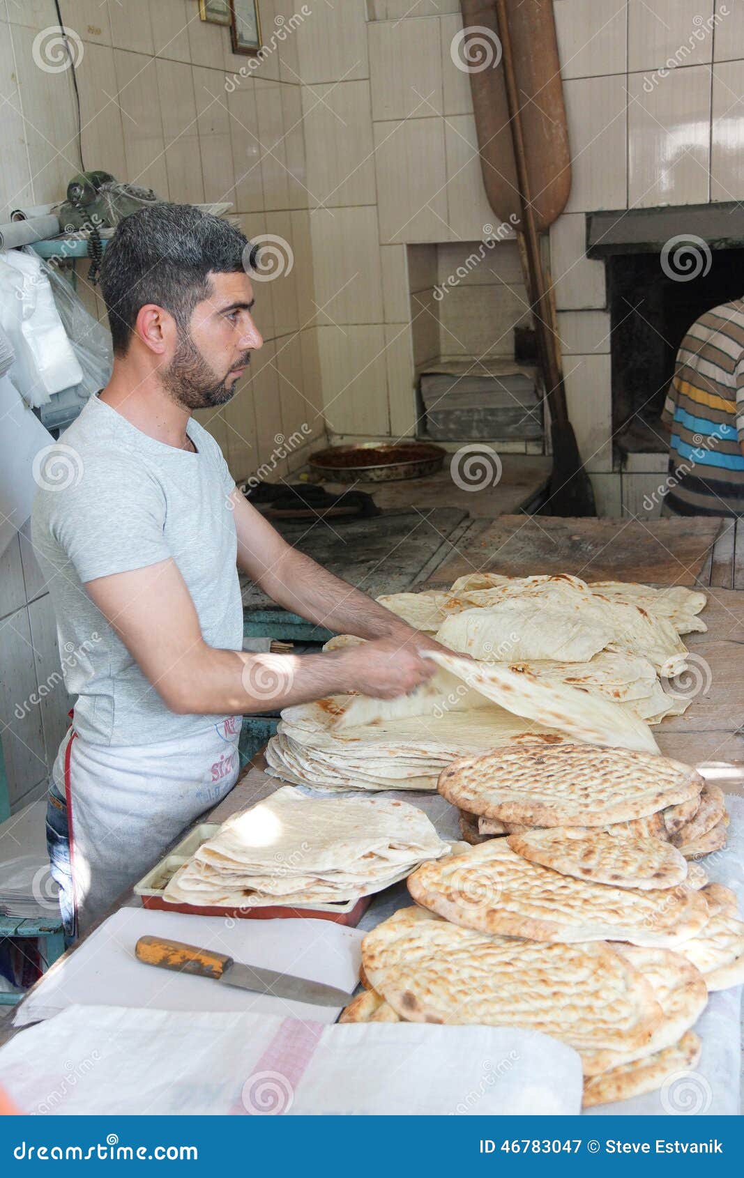 Baker prepares flatbread editorial photography. Image of knead 46783047