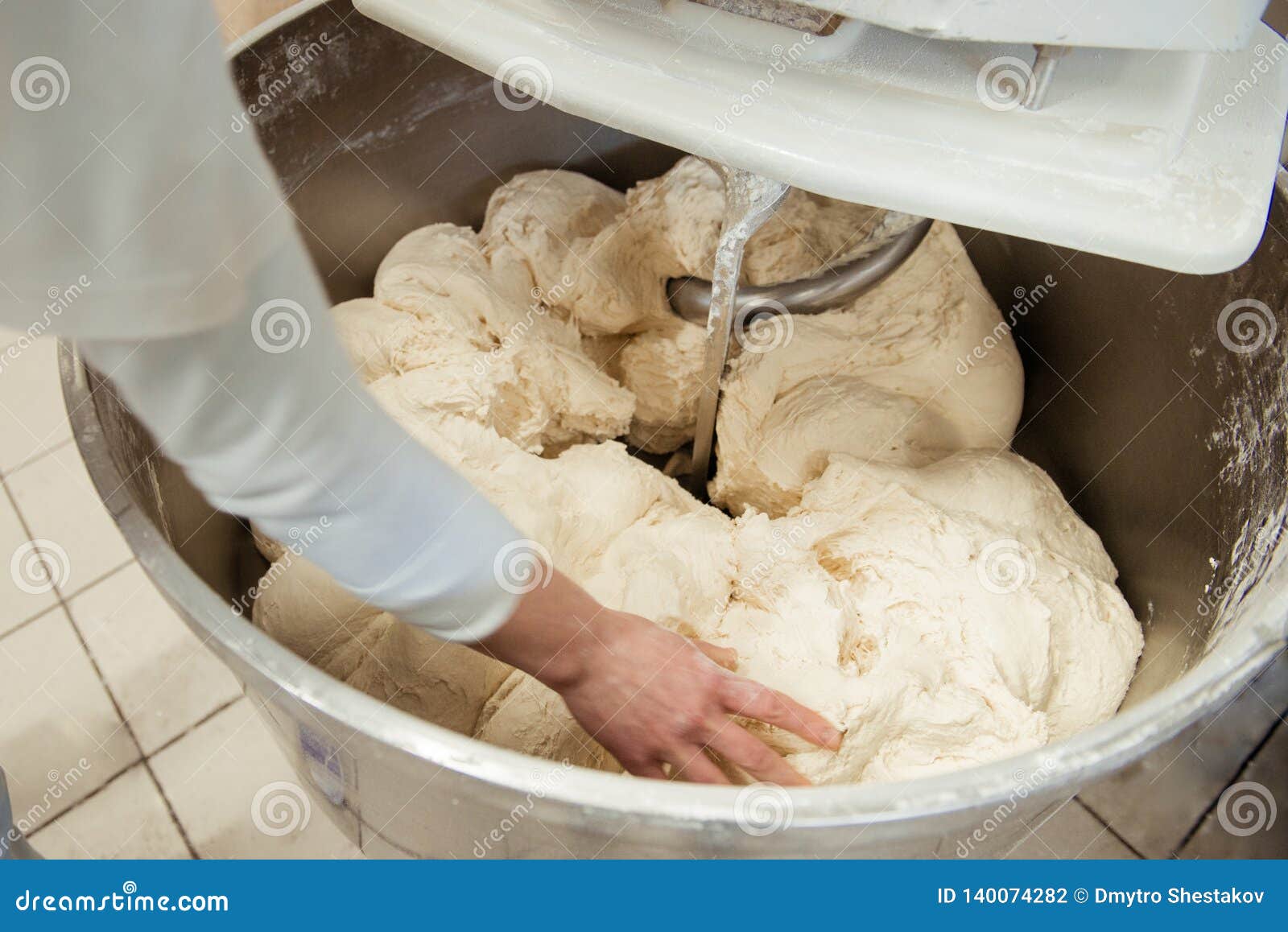 Baker Preparing the Dough for Bread in a Dough Mixer Stock Photo