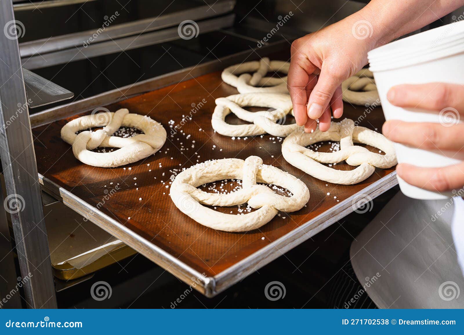 Baker Salting Raw Pretzels on a Baking Sheet Stock Photo Image of food, bakery 271702538