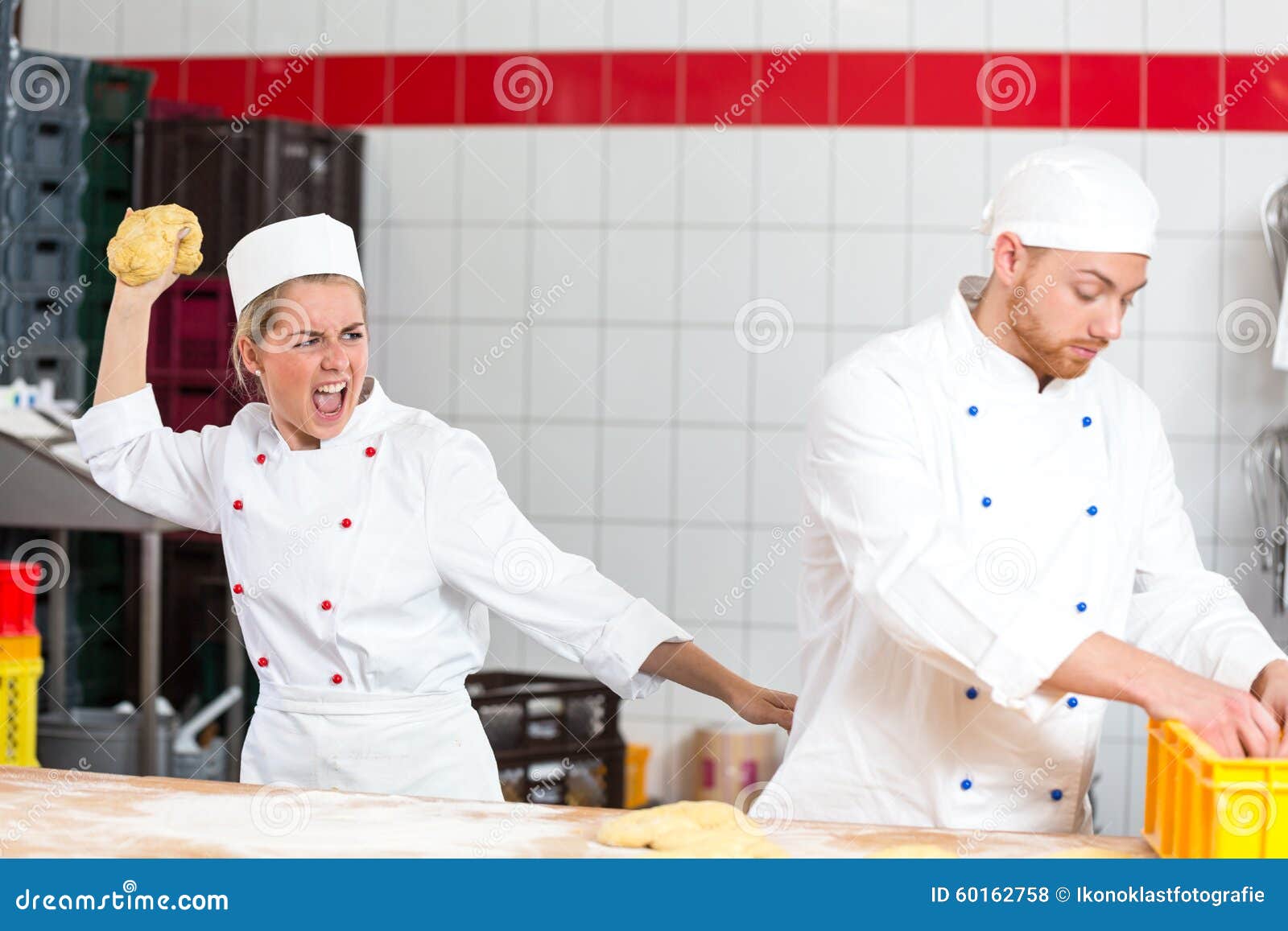 Baker Who is Frustrated with Collegue Throwing Dough at Him Stock Photo