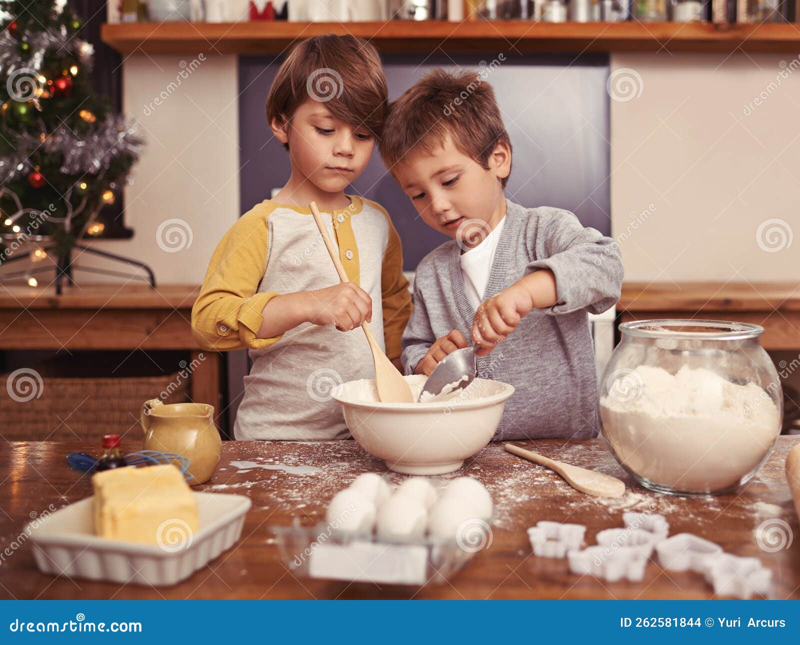 Baking with His Brother. Two Young Brothers Baking in the Kitchen