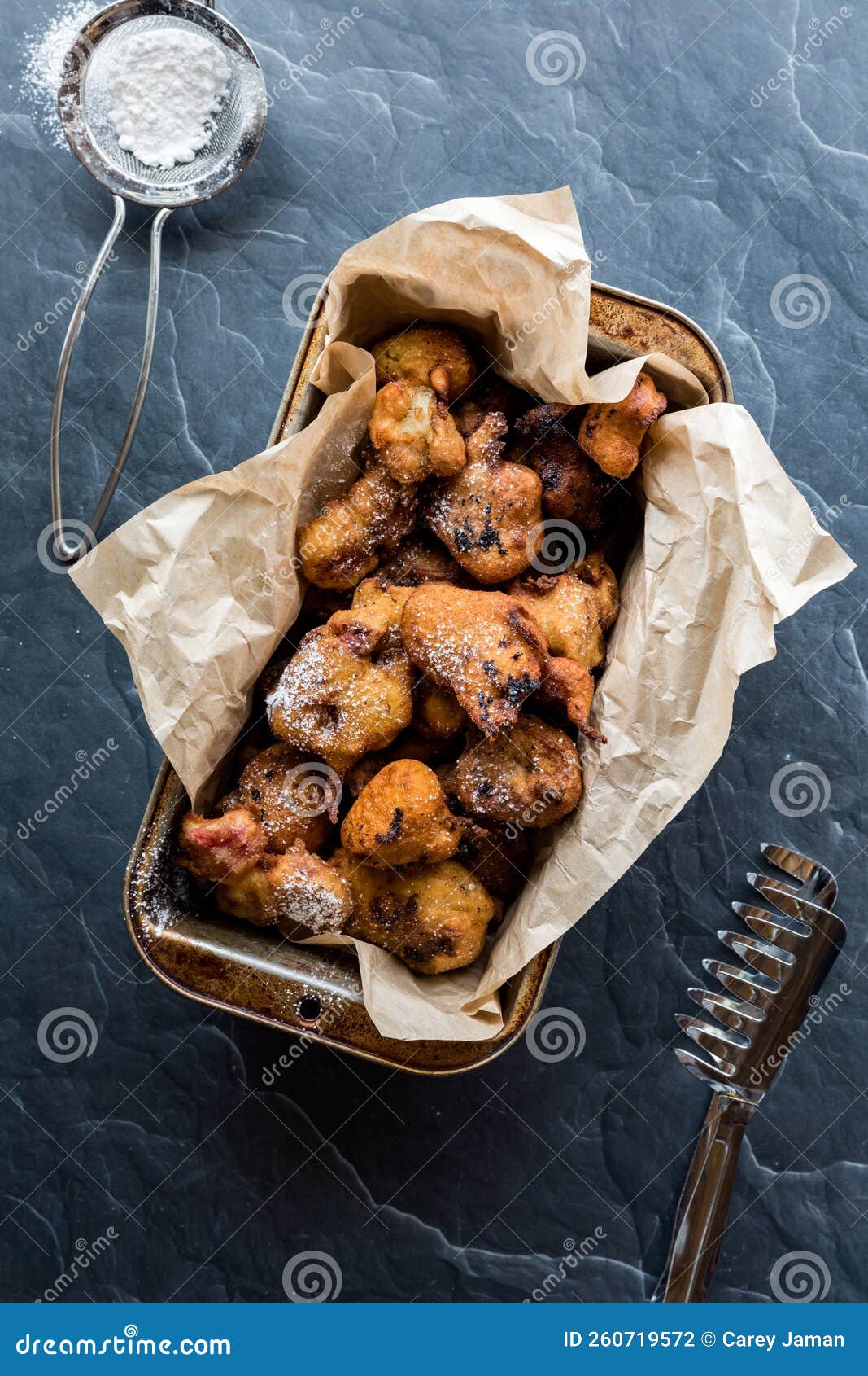 A Baking Pan Lined with Parchment Paper Filled with Deep Fried Fritters