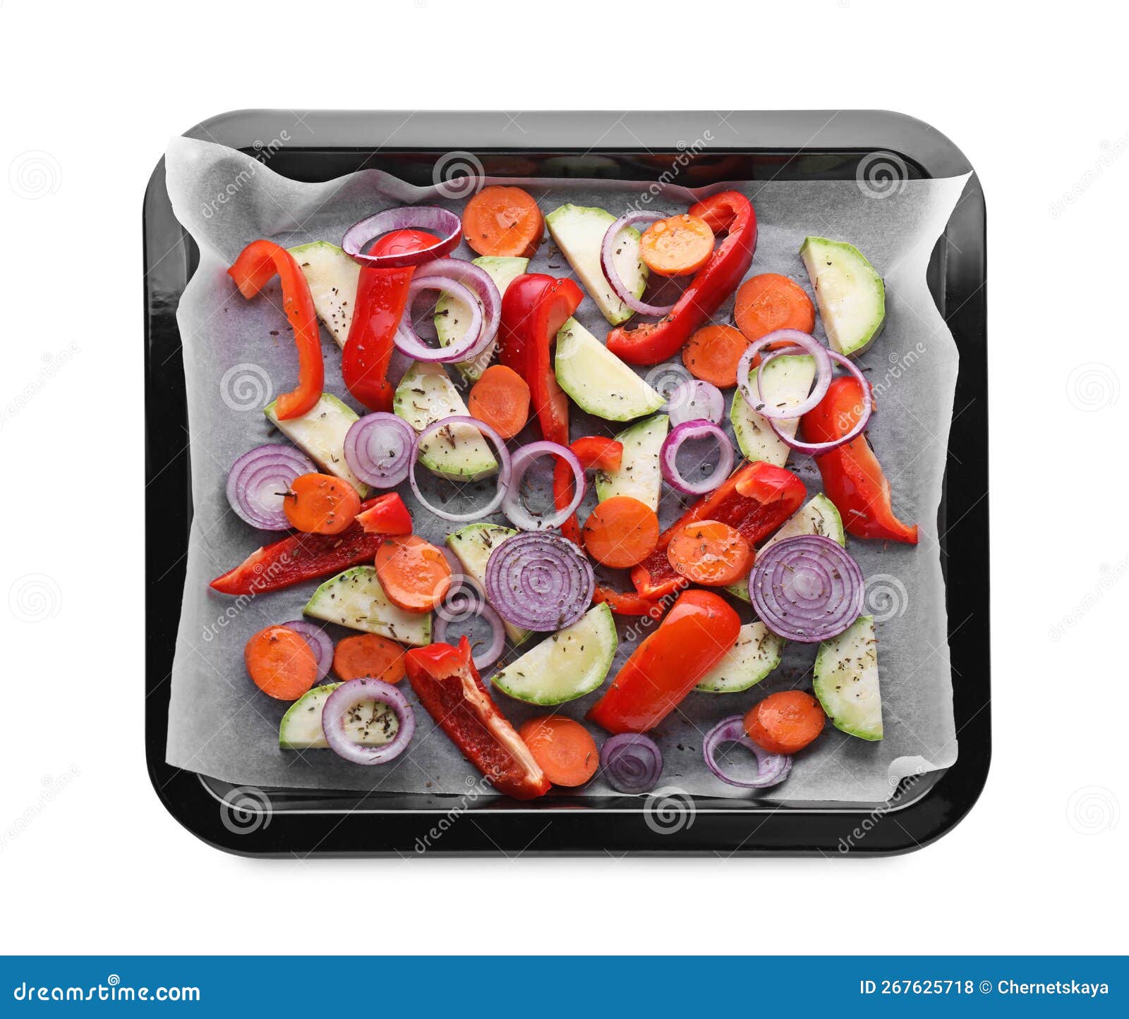 Baking Pan with Parchment Paper and Raw Vegetables Isolated on White, Top View Stock Photo