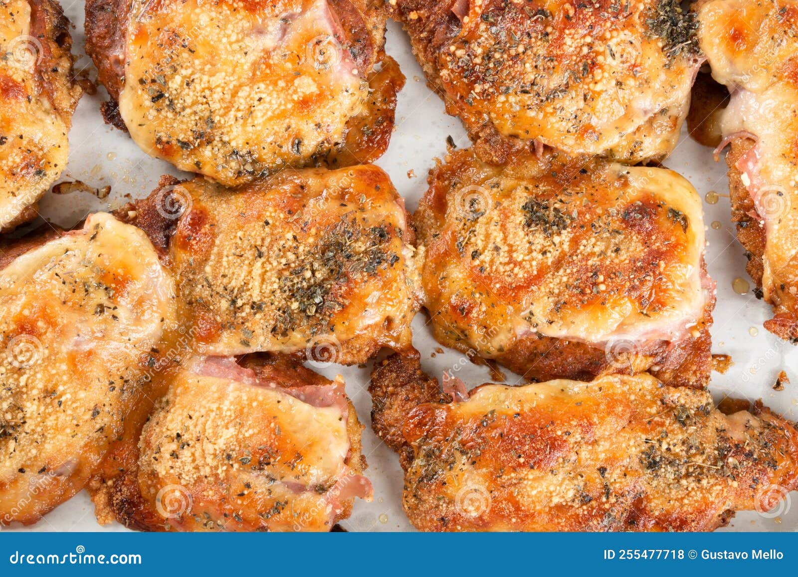 Baking Pan with Pieces of Roasted Chicken Covered in Cheese Stock Photo