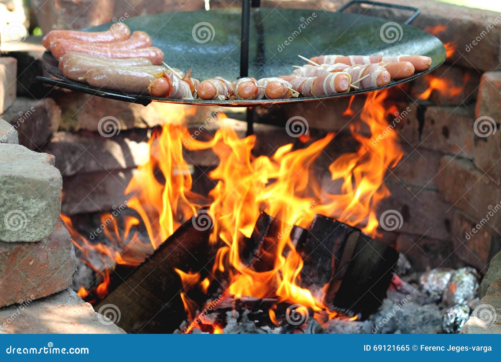 baking sausages at the campfire