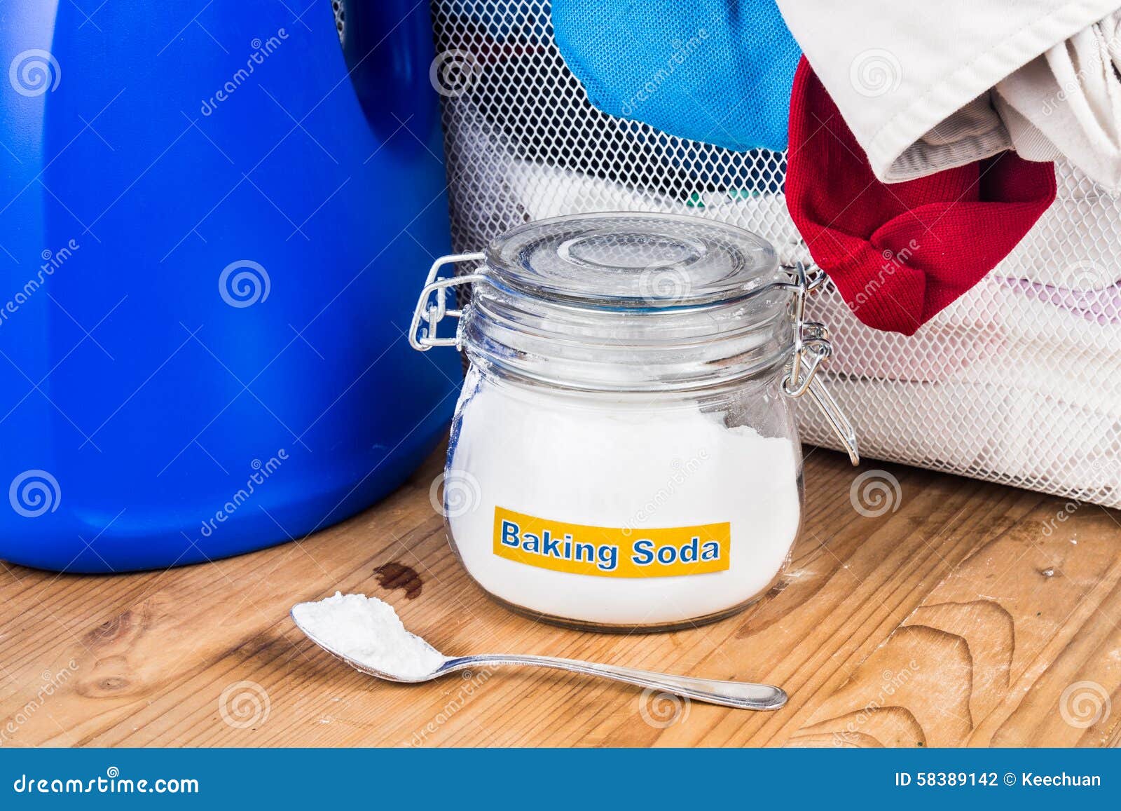 Baking Soda with Detergent and Pile of Dirty Laundry. Stock Photo