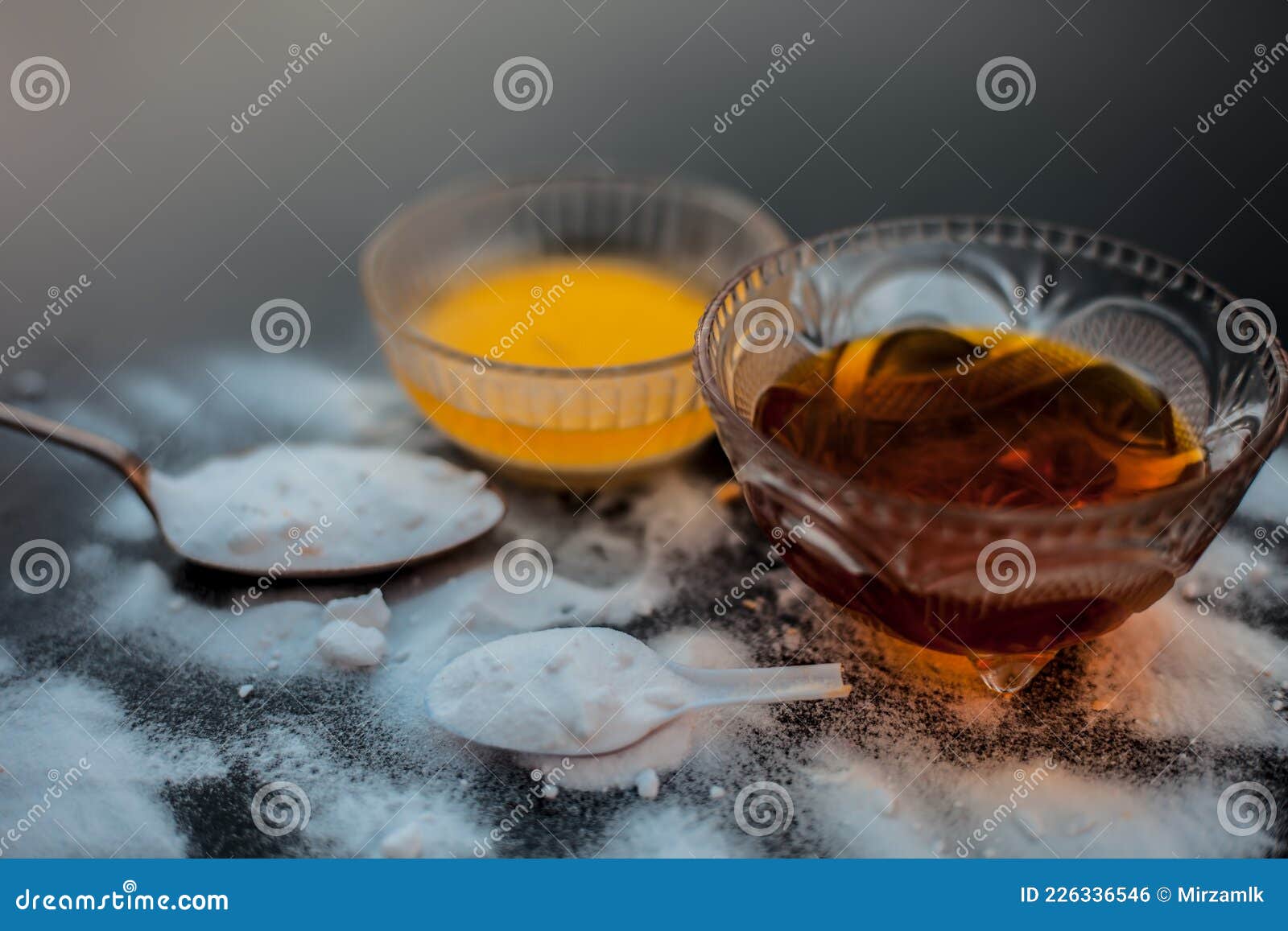 baking soda face mask in a glass bowl on wooden surface along with baking soda powder and honey and eggs