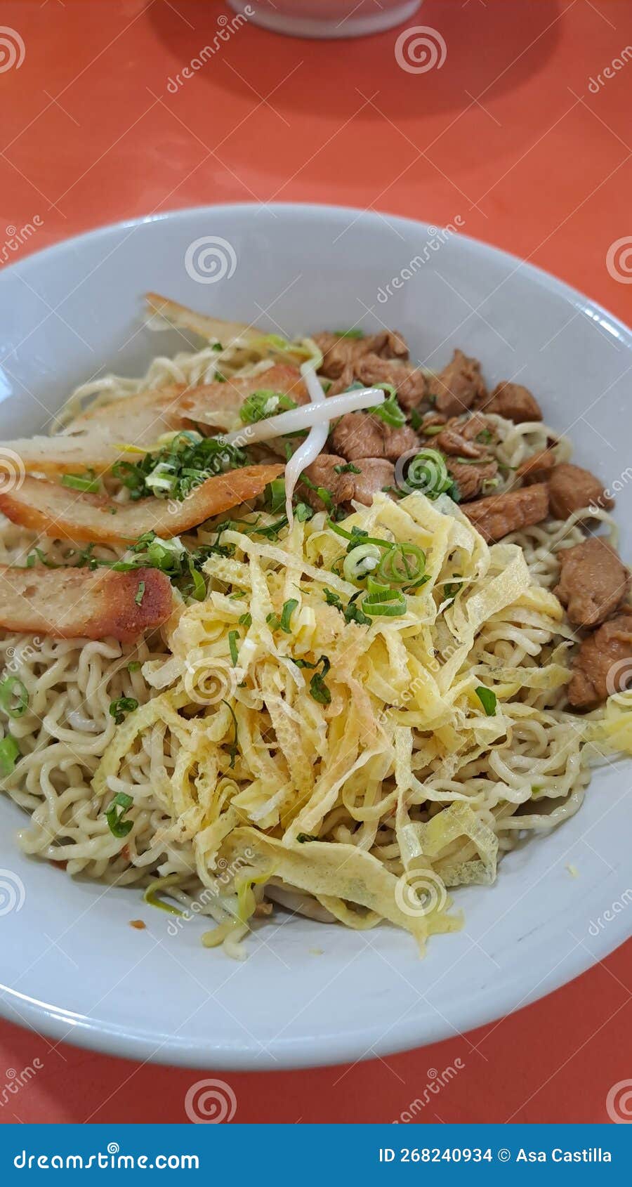 Bakmie is Dry Noodle with Chicken, Egg Sliced, Sprouts and Dumplings