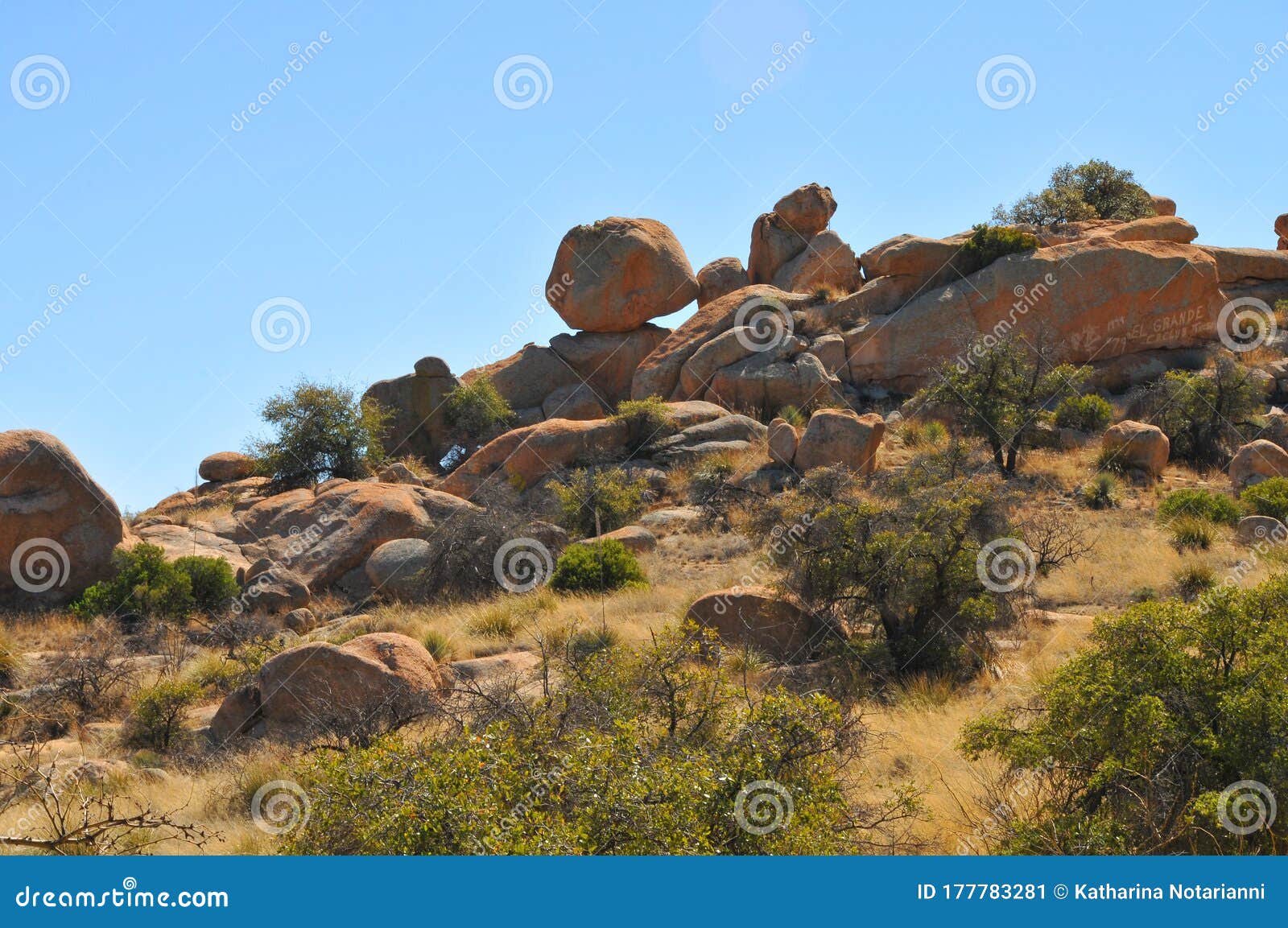 balance rock - desert terrain mountain rocks against a bright blue cloudless sky