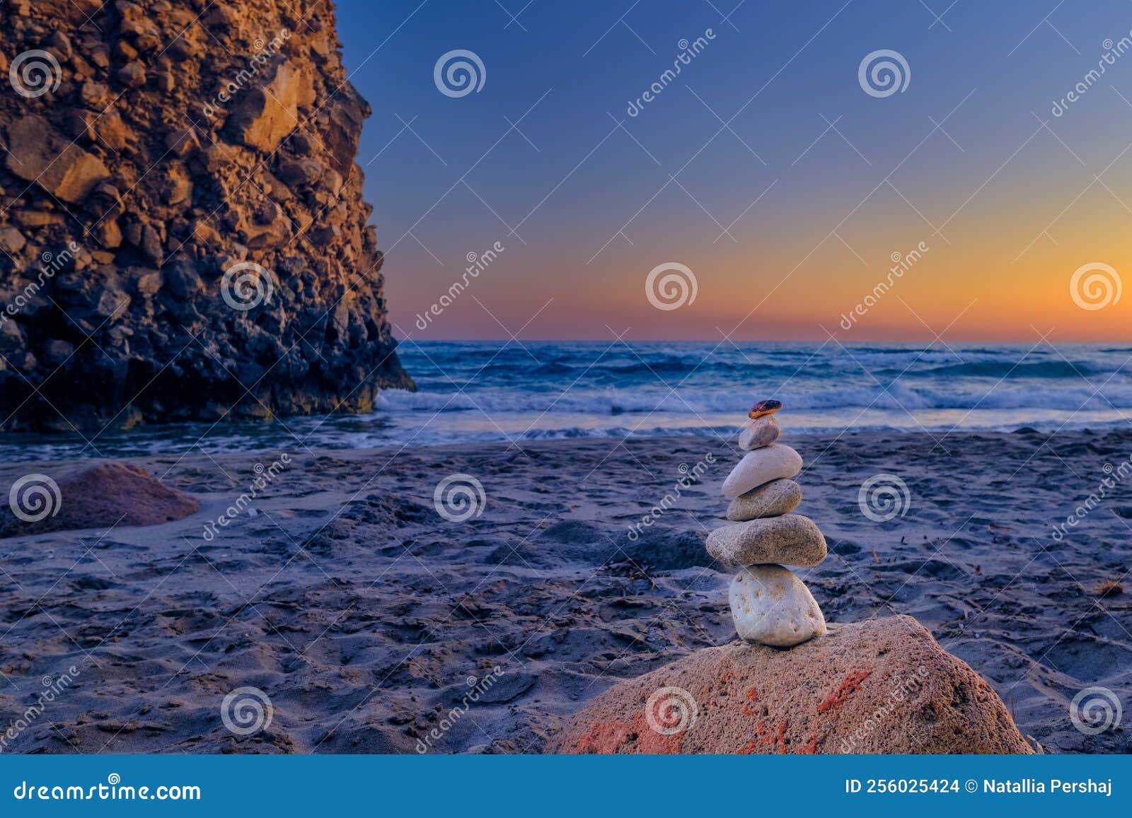 Balance Stone Stack and Big Natural Rock on Sandy Beach at Sunset. Stock Photo Image of cairn