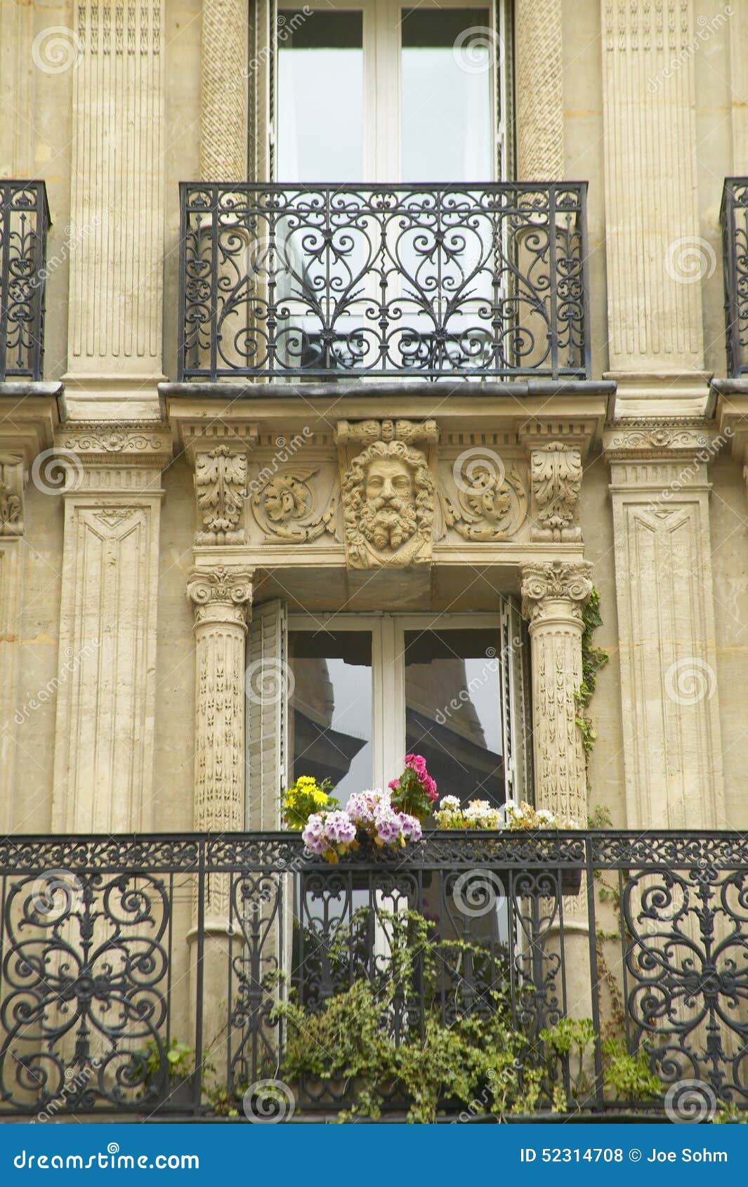 balcony with carved statuary of apartment, paris, france