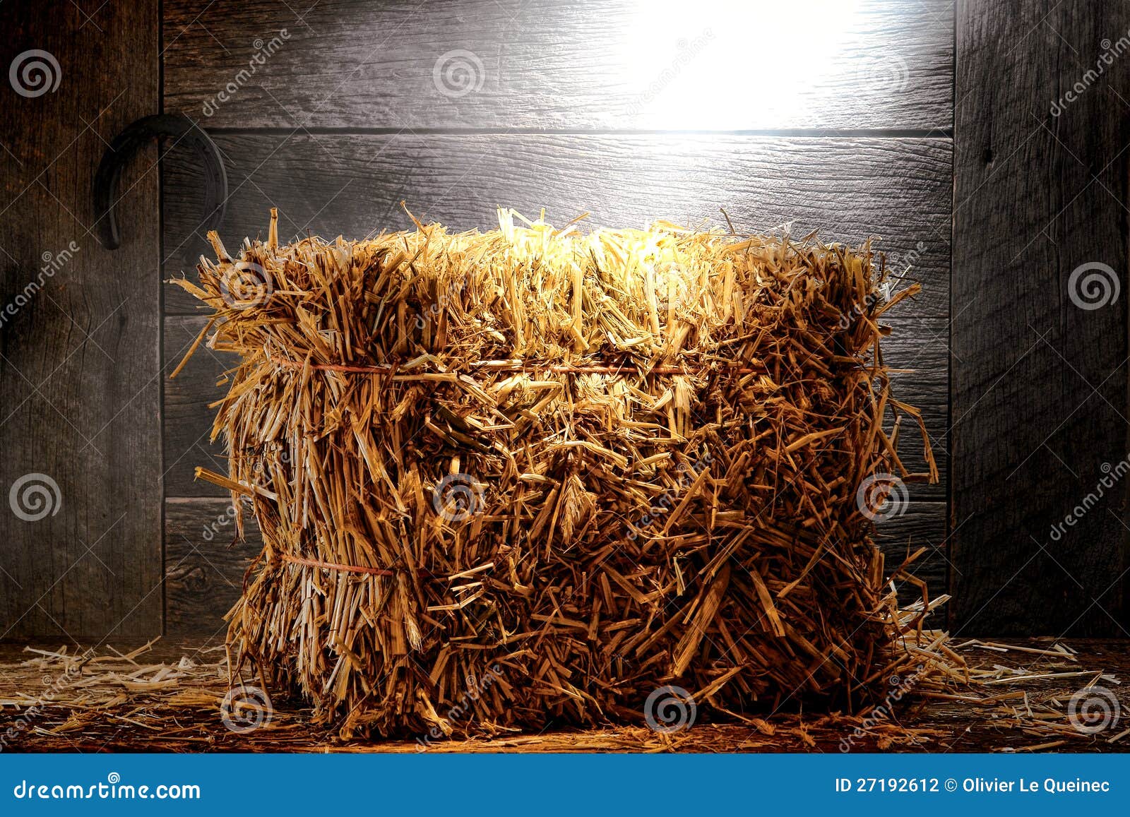 Bale of Straw Hay in Old Dusty Farm or Ranch Barn Stock Photo Image