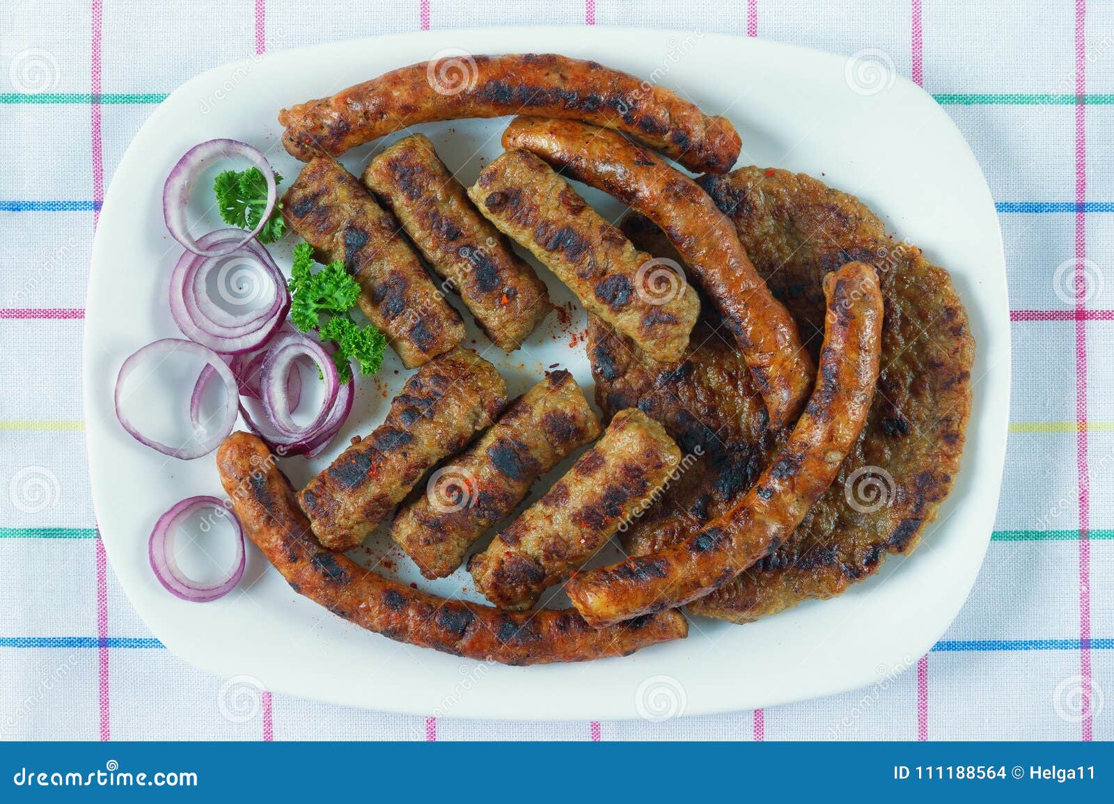 balkan cuisine. cevapi, kobasica and pljeskavica - grilled dish of minced meat. flat lay