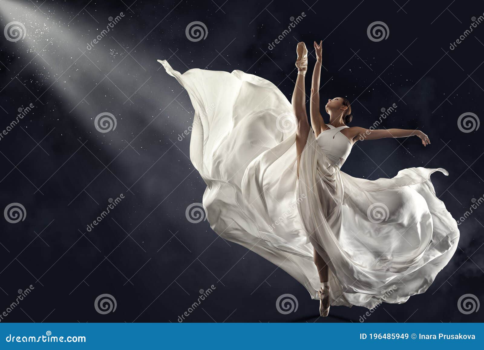 ballerina jumping in white silk dress, modern ballet dancer in pointe shoes, fluttering waving cloth, gray background