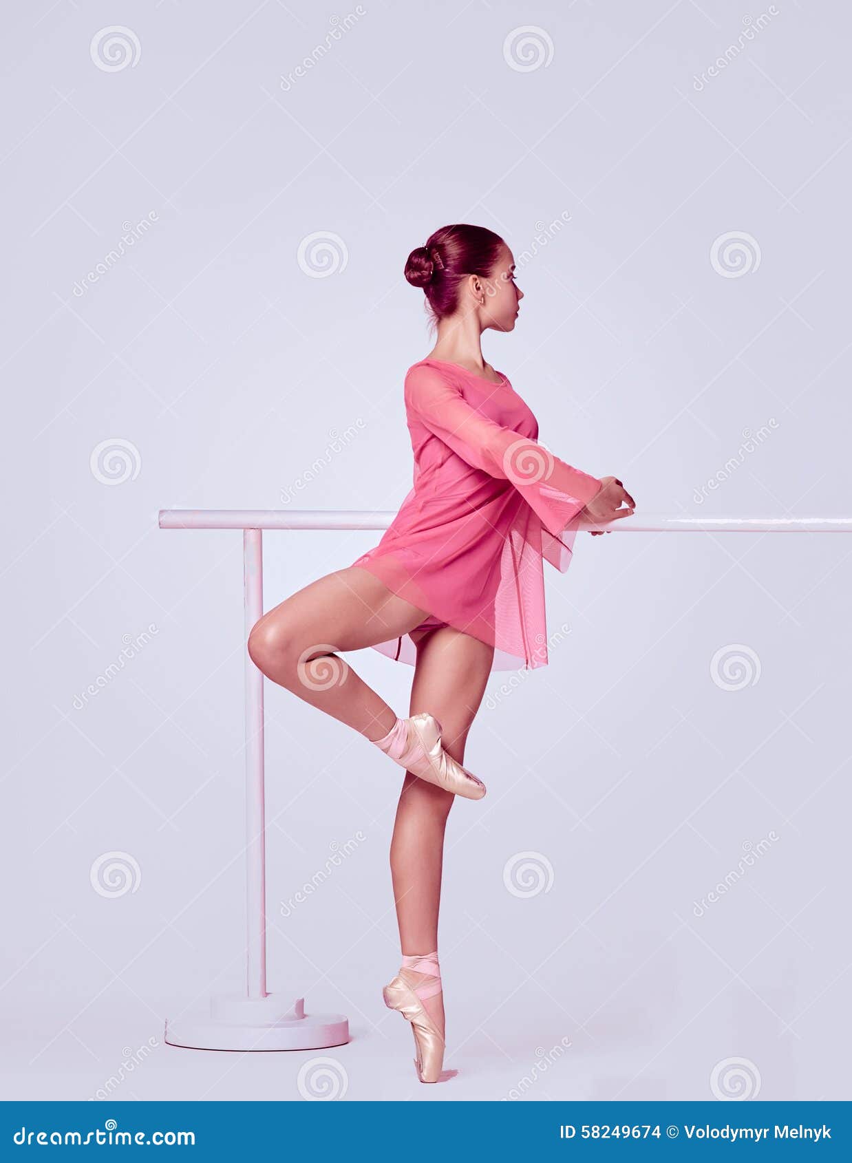 ballerina stretching on the bar