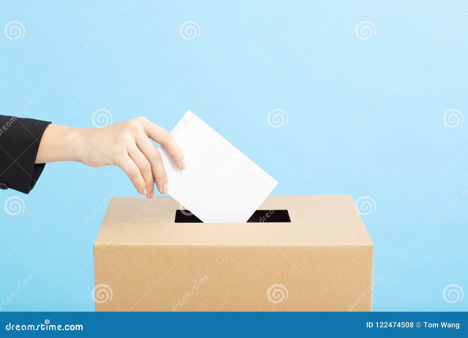 ballot box with person casting vote on blank voting slip