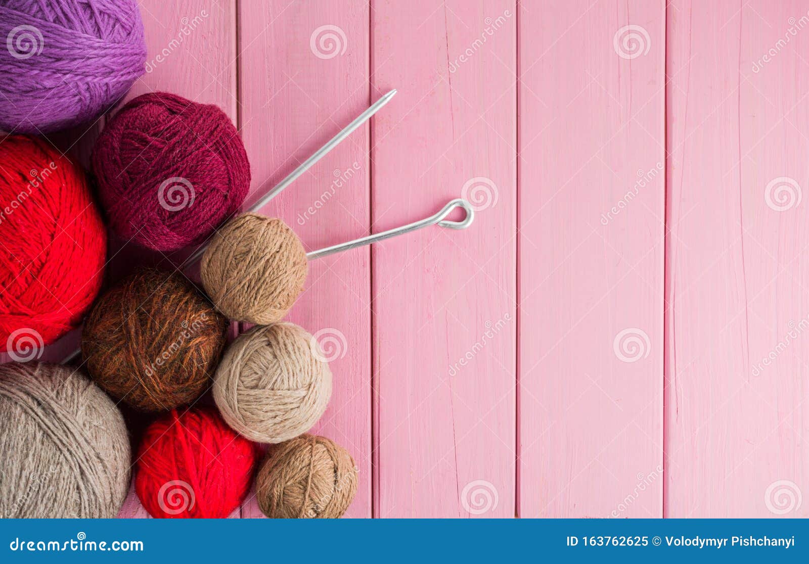 balls of yarn in different colors with knitting needles