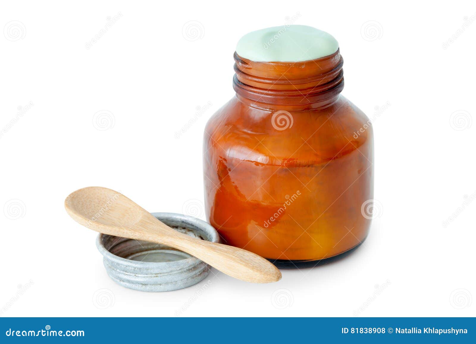 a balm jar full of medicated ointment and spoon.